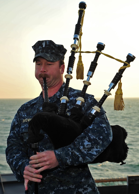 121201-N-YQ852-021 U.S. 5TH FLEET AREA OF RESPONSIBILITY (Dec. 01, 2012) - - Lt. j.g. James Brown, training officer, plays bagpipes during a change of command ceremony aboard amphibious dock landing ship USS Rushmore (LSD 47). During the ceremony, Cmdr. Tate Robinson relieved Cmdr. Brian Finman as commanding officer of Rushmore. Rushmore is a part of the Peleliu Amphibious Ready Group, with the embarked 15th Marine Expeditionary Unit, and is deployed in support of maritime security operations and theater security cooperation efforts in the U.S. 5th Fleet area of responsibility. (U.S. Navy photo by Mass Communication Specialist 3rd Class Shawnte Bryan/Released)