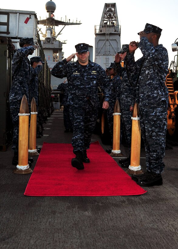 121201-N-YQ852-004 U.S. 5TH FLEET AREA OF RESPONSIBILITY (Dec. 01, 2012) - - Cmdr. Tate Robinson passes through ceremonial sideboys before relieving Cmdr. Brian Finman as commanding officer of amphibious dock landing ship USS Rushmore (LSD 47). Rushmore is a part of the Peleliu Amphibious Ready Group, with the embarked 15th Marine Expeditionary Unit, and is deployed in support of maritime security operations and theater security cooperation efforts in the U.S. 5th Fleet area of responsibility. (U.S. Navy photo by Mass Communication Specialist 3rd Class Shawnte Bryan/Released)