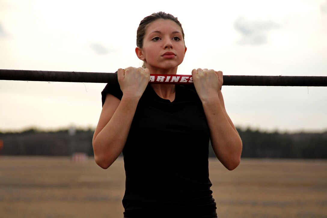 Ariel Arvidson, a 17-year-old junior at Coon Rapids High School, maxes out her time during the flexed-arm hang portion of an initial strength test at the Recruiting Station Twin Cities mini boot camp May 6. Arvidson was recruited out of the Coon Rapids, Minn., office by Staff Sgt. Jowa J. Wildes. For additional imagery from the event, visit www.facebook.com/rstwincities.