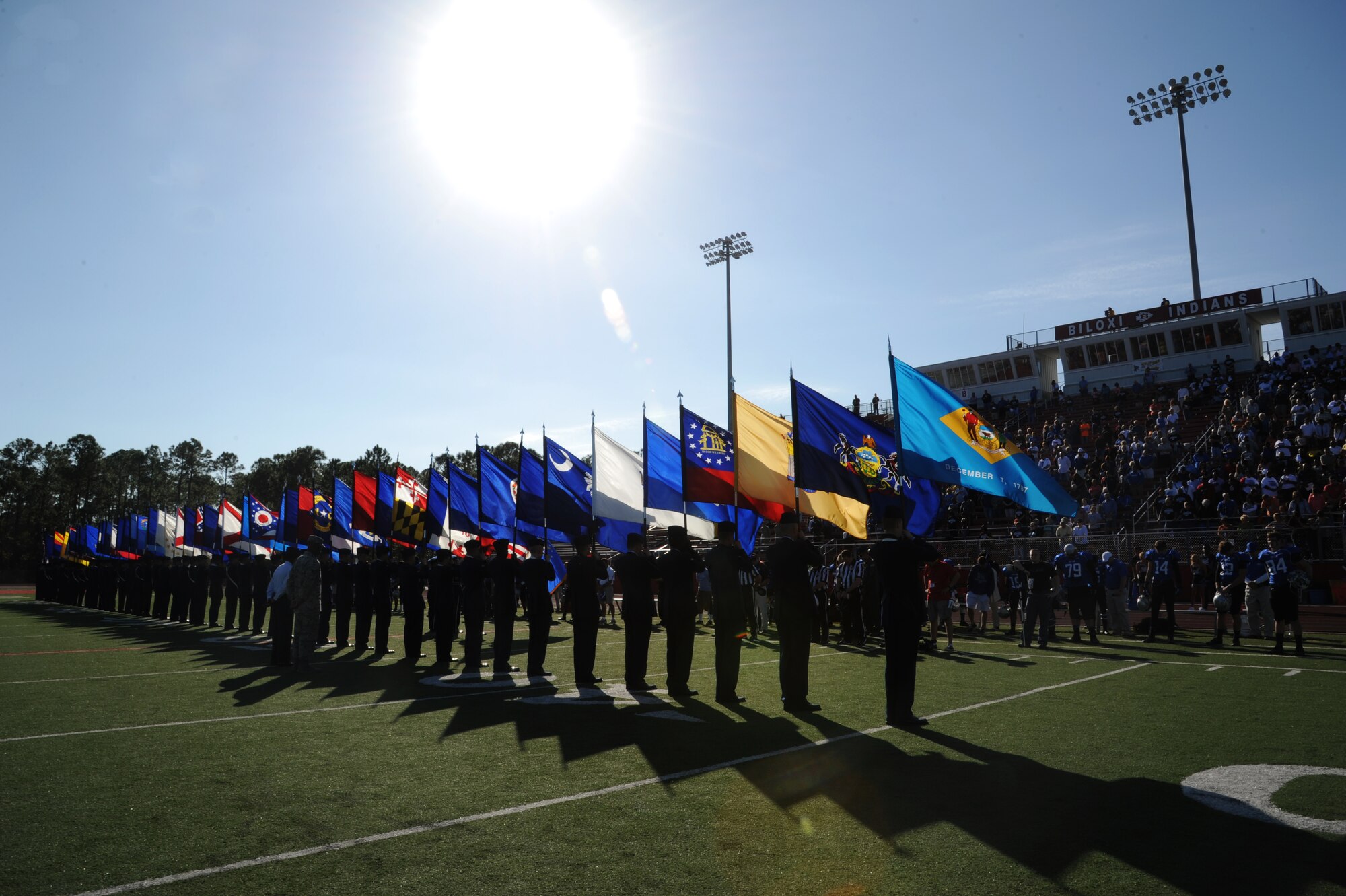 Airmen from Keesler Air Force Base, Miss., line the field while carrying the 50-State flags during a pre-game celebration at the 2012 Mississippi Bowl at the Biloxi High School football stadium Dec. 2, 2012.  Other Keesler participation included the Honor Guard, a C-130J Hercules fly over by the 403rd Wing and a drill down performance by the 81st Training Group.  (U.S. Air Force photo by Kemberly Groue)