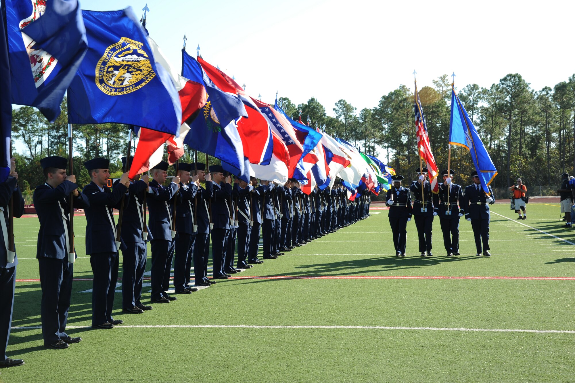 The 50-State flag team and the honor guard from Keesler Air Force Base, Miss., line the field during the pre-game celebration at the 2012 Mississippi Bowl at the Biloxi High School football stadium Dec. 2, 2012.  Other Keesler participation included a C-130J Hercules fly over by the 403rd Wing and a drill down performance by the 81st Training Group.  (U.S. Air Force photo by Kemberly Groue)