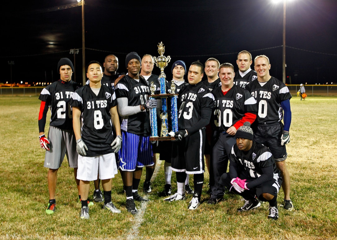 The 31st Test and Evaluation Squadron Desert Pirates pose for a team photo after claiming the Edwards intramural flag football championship Nov. 29 at Wings Field. The 31st TES defeated the 412th Medical Group 32-21 after only finishing the season with 4 wins and 4 losses. (U.S. Air Force photo by Jet Fabara)