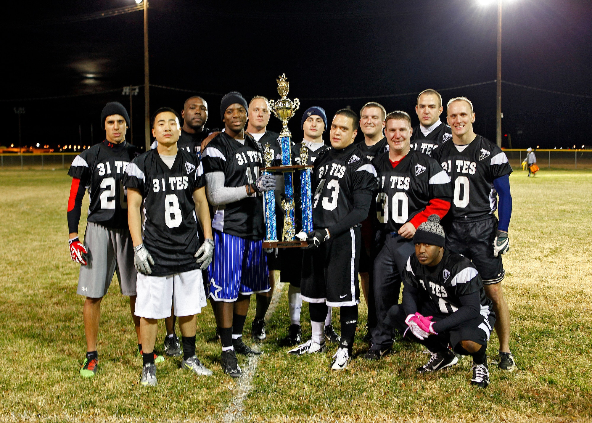 The 31st Test and Evaluation Squadron Desert Pirates pose for a team photo after claiming the Edwards intramural flag football championship Nov. 29 at Wings Field. The 31st TES defeated the 412th Medical Group 32-21 after only finishing the season with 4 wins and 4 losses. (U.S. Air Force photo by Jet Fabara)