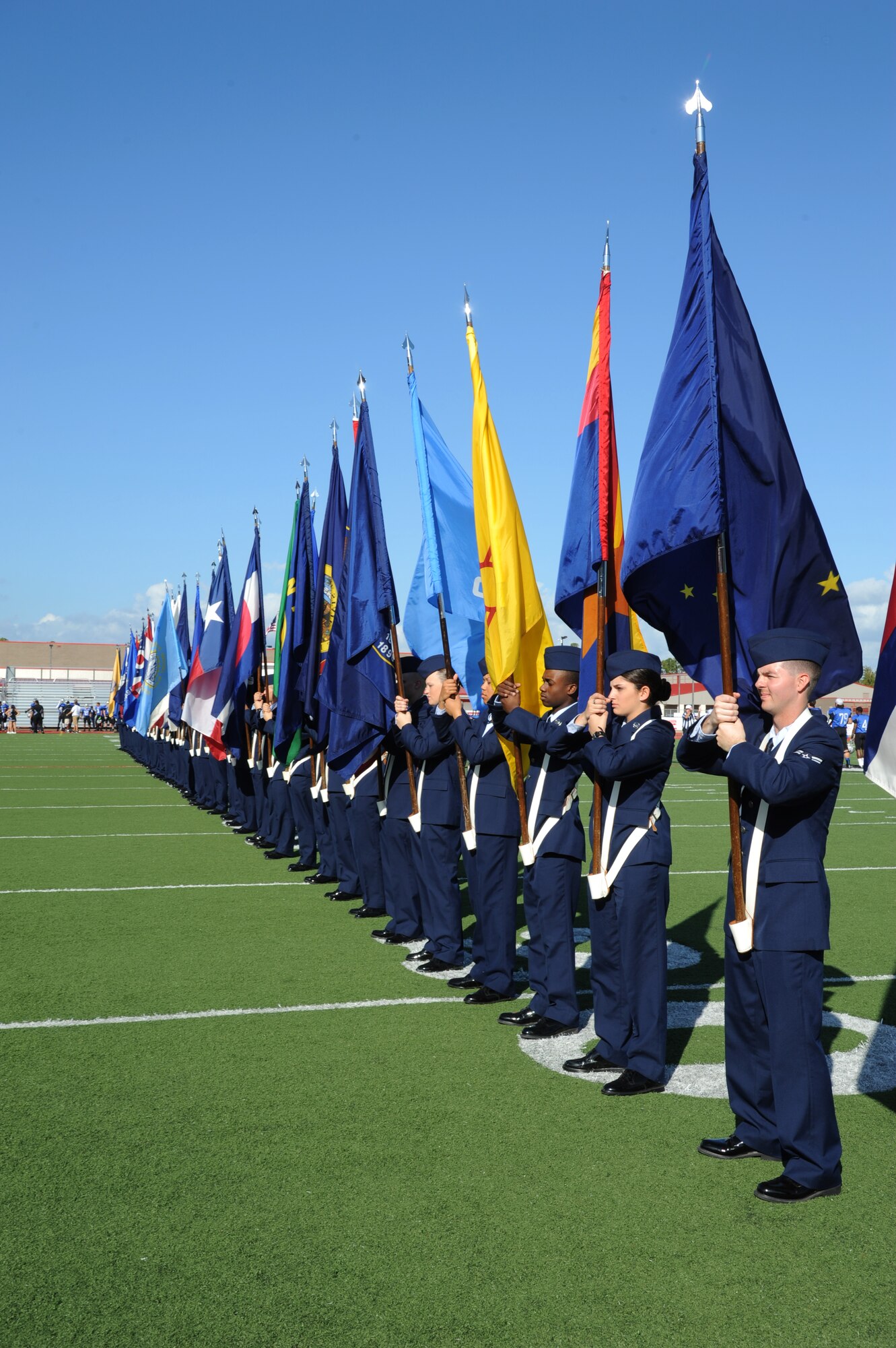 Airmen from Keesler Air Force Base, Miss., line the field while carrying the 50-State flags during a pre-game celebration at the 2012 Mississippi Bowl at the Biloxi High School football stadium Dec. 2, 2012.  Other Keesler participation included the Honor Guard, a C-130J Hercules fly over by the 403rd Wing and a drill down performance by the 81st Training Group.  (U.S. Air Force photo by Kemberly Groue)