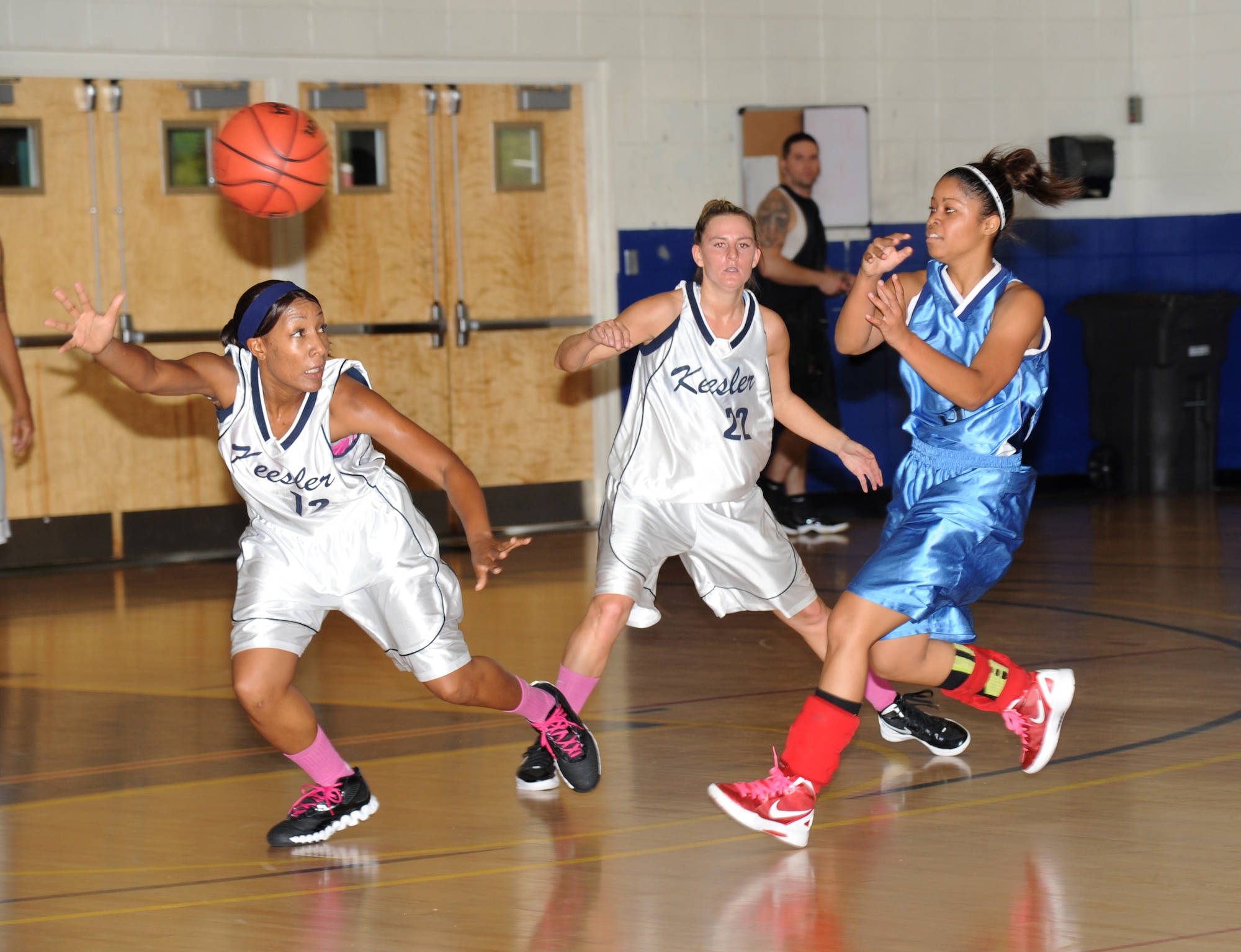 Tomeika Washington and Brittany Deichmann, Keesler white team, play defense against Kirsten Piernas, Keesler blue team, during an inner-squad scrimmage among the Women’s varsity basketball team Dec. 1, 2012, at the Blake Fitness Center, Keesler Air Force Base, Miss. The Keesler white team defeated the Keesler blue team, 45-30.  (U.S. Air Force photo by Kemberly Groue)