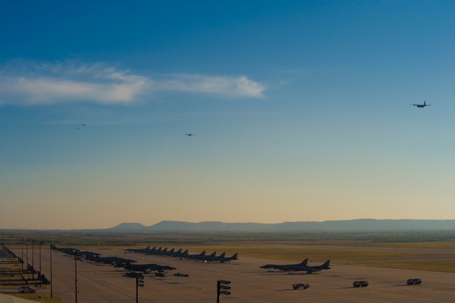 A formation of C-130Js take off during a training exercise Nov. 30, 2012, at Dyess Air Force Base, Texas. The C-130J incorporates state-of-the-art technology to reduce manpower requirements, lower operating and support costs, and provides life-cycle cost savings over earlier C-130 models. Compared to older C-130s, the J model climbs faster and higher, flies farther at a higher cruise speed, and takes off and lands in a shorter distance. Dyess has received 23 J models and is scheduled to get a total of 28, making it the largest C-130J unit in the world. (U.S. Air Force photo by Staff Sgt. Richard P. Ebensberger/ Released)