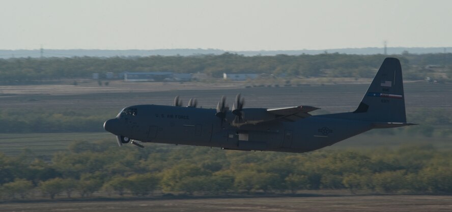 A C-130J assigned to the 317th Airlift Group takes off during a training exercise Nov. 30, 2012, at Dyess Air Force Base, Texas. The C-130J incorporates state-of-the-art technology to reduce manpower requirements, lower operating and support costs, and provides life-cycle cost savings over earlier C-130 models. Compared to older C-130s, the J model climbs faster and higher, flies farther at a higher cruise speed, and takes off and lands in a shorter distance. Dyess has received 23 J models and is scheduled to get a total of 28, making it the largest C-130J unit in the world. (U.S. Air Force photo by Staff Sgt. Richard P. Ebensberger/ Released)