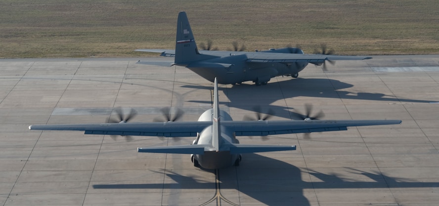 C-130Js taxi toward the runway during a training exercise Nov. 30, 2012, at Dyess Air Force Base, Texas. The C-130J incorporates state-of-the-art technology to reduce manpower requirements, lower operating and support costs, and provides life-cycle cost savings over earlier C-130 models. Compared to older C-130s, the J model climbs faster and higher, flies farther at a higher cruise speed, and takes off and lands in a shorter distance. Dyess has received 23 J models and is scheduled to get a total of 28, making it the largest C-130J unit in the world. (U.S. Air Force photo by Staff Sgt. Richard P. Ebensberger/ Released)