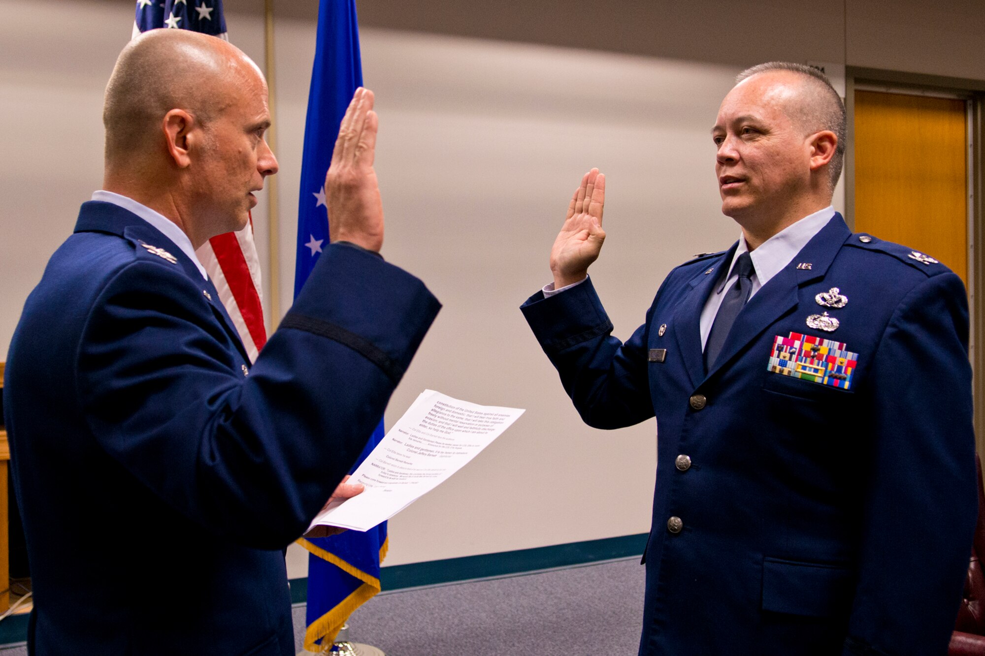 U.S. Air Force Col. Jeffery Barnett (right) repeats the Oath of Office to Col. Jonathan Ellis, 307th Bomb Wing commander, during a Pinning On ceremony, Dec. 1, 2012, Barksdale Air Force Base, La. Barnett is the commander of the 307th Rapid Engineer Deployable Heavy Operational Repair Squadron. (U.S. Air Force photo by Master Sgt. Greg Steele/Released)