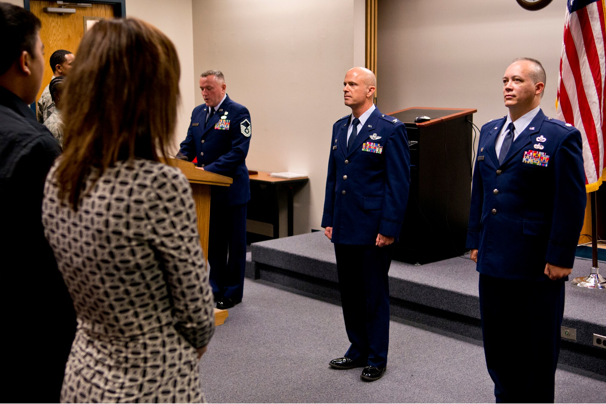 Nora and Nathan Barnett stand as the promotion orders are read for U.S. Air Force Col. Jeffery Barnett (right) during a Pinning On ceremony, Dec. 1, 2012, Barksdale Air Force Base, La. Barnett was recently promoted to colonel and is the commander of the 307th Rapid Engineer Deployable Heavy Operational Repair Squadron. (U.S. Air Force photo by Master Sgt. Greg Steele/Released)