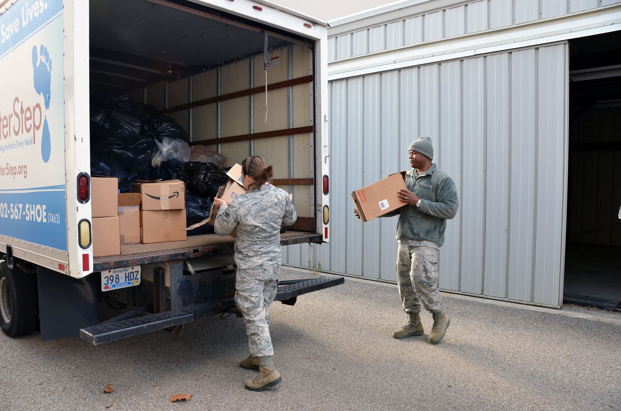 WRIGHT-PATTERSON AIR FORCE BASE, Ohio - 445th Airlift Wing Airman's Council members Senior Airman Laura Wagner and Senior Airman Joshua Walker help load more than 3,000 pairs of shoes (4,000 pounds) donated by members of the wing to be given to the EDGE Outreach's "Shoes for Water" program. The collected shoes will help to raise money for water purification projects and keep used shoes out of landfills. (U.S. Air Force photo/Stacy Vaughn)