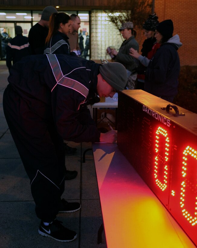 An Airman fills out an Air Force Sergeants Association member sign-up sheet at West Fitness Center, Nov. 30, 2012. AFSA Chapter 102 recruited members by hosting the Jingle Bell Jaunt 5k. After the run they had prize drawings and free gifts. AFSA is a federally chartered, non-profit organization whose members consist of Air Force service members of all grades and ranks of active duty, national guard, reserve, veterans, retirees, and their families. (U.S. Air Force photo/Airman 1st Class Nesha Humes)(Released)