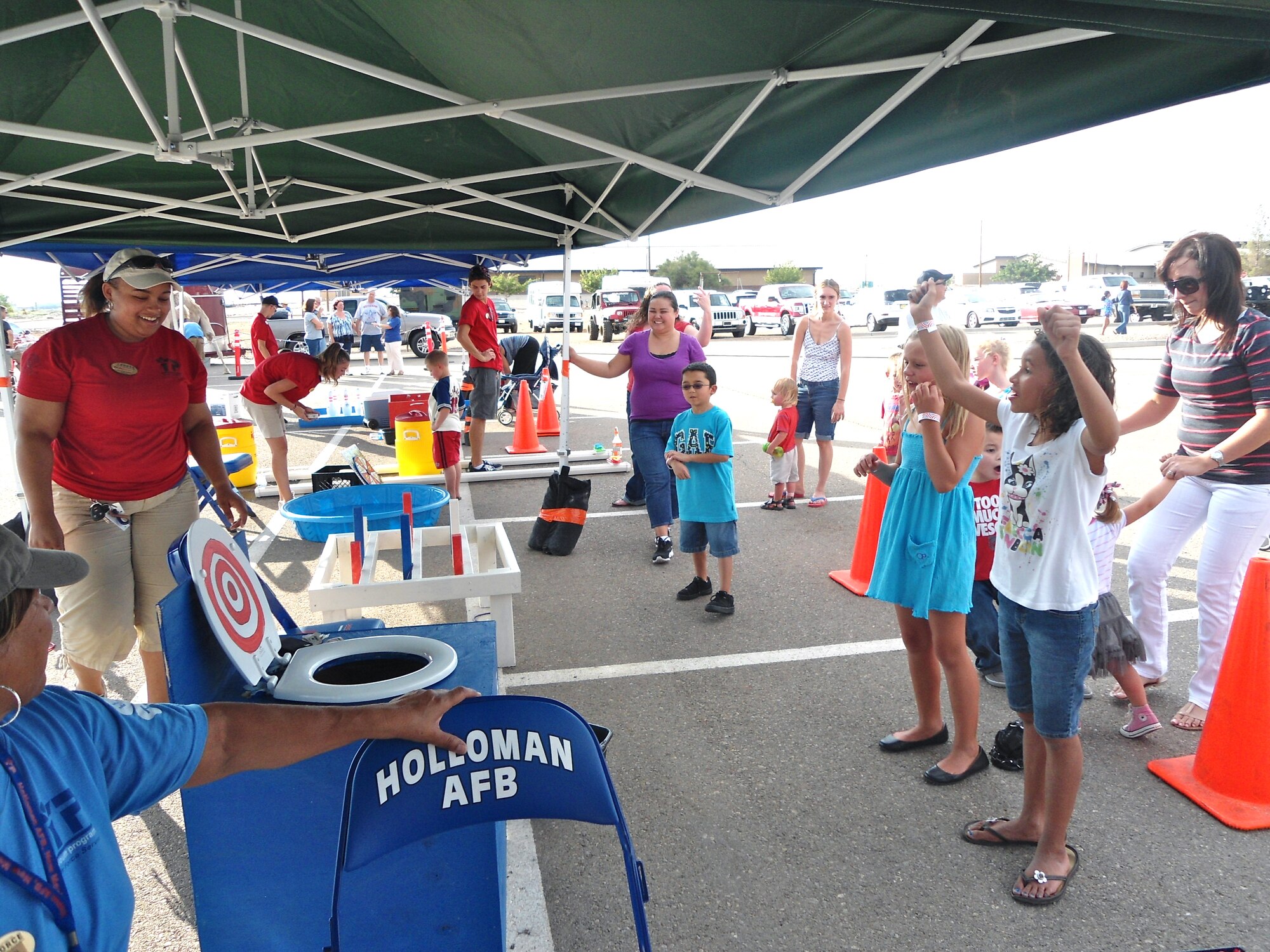Staff members of the Holloman Air Force Base, N.M., Youth and Teen Center man different carnival-style game booths for the Freedom Fest Independence Day celebration at the Domenici Fitness and Sports Center parking lot July 3. In addition to events like the Freedom Fest, the Youth and Teen Center also takes part in and hosts different camps, ranging from music, digital arts, physical fitness, and sewing. The Youth and Teen Center’s goal is to implement the Boys and Girls Clubs of America five core areas – health and life skills, character and leadership, fitness and recreation, education and career, and the arts – into every activity they offer. (Courtesy photo)