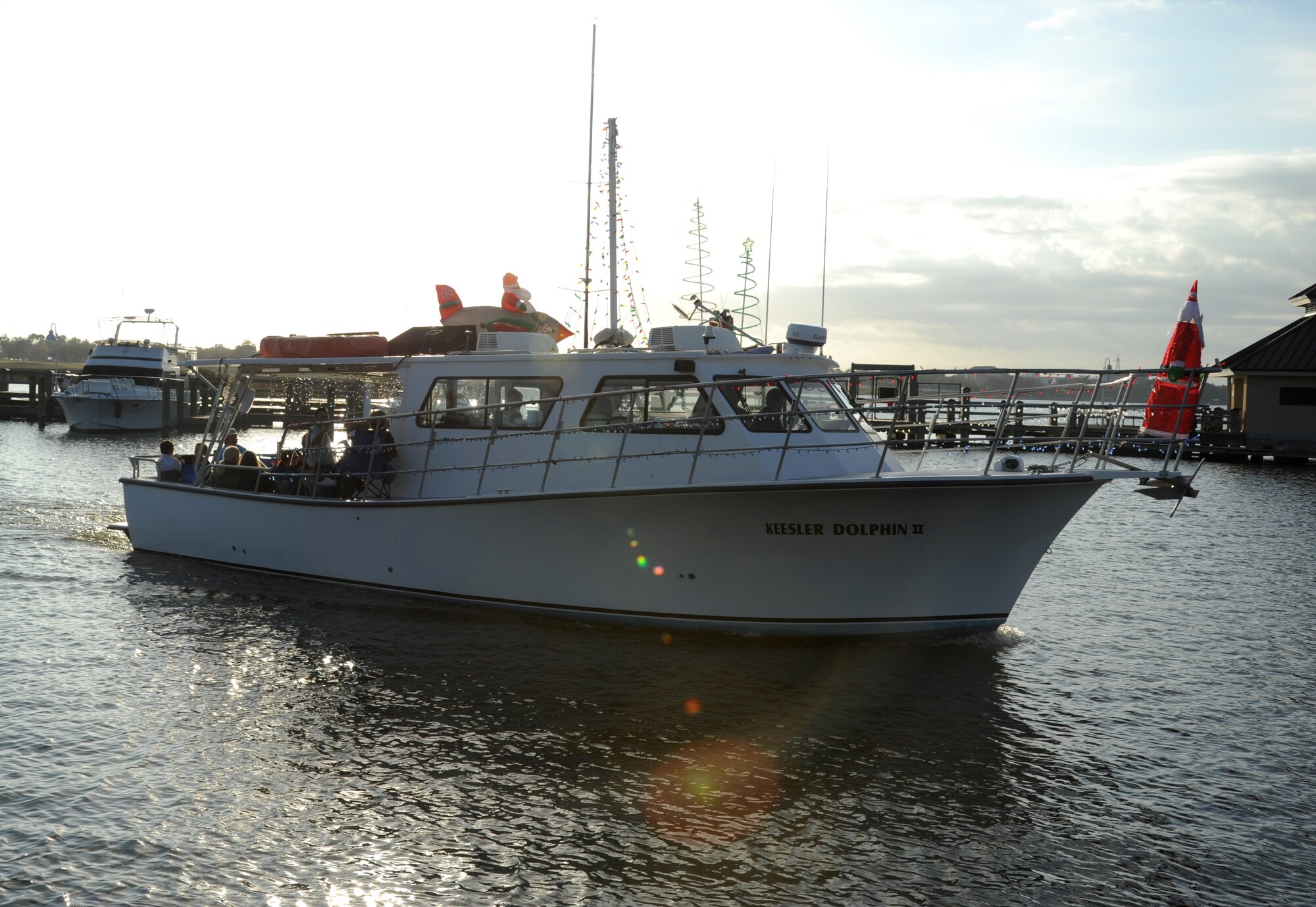 The Keesler Dolphin II leaves the Keesler Marina Dec. 1, 2012, to participate in the 27th Annual Christmas on the Water boat parade along the Mississippi Gulf Coast in Biloxi. Boats parade in full holiday décor with a fireworks show after the parade. The Dolphin, which was captained by Jim Young and Dave Bowers, was awarded third place in the commercial boats category.  Col. Rene Romero, 81st Training Wing vice commander, and retired Brig. Gen. Rich Moss, former 403rd Wing commander, participated as judges for the event.  (U.S. Air Force photo by Kemberly Groue)
