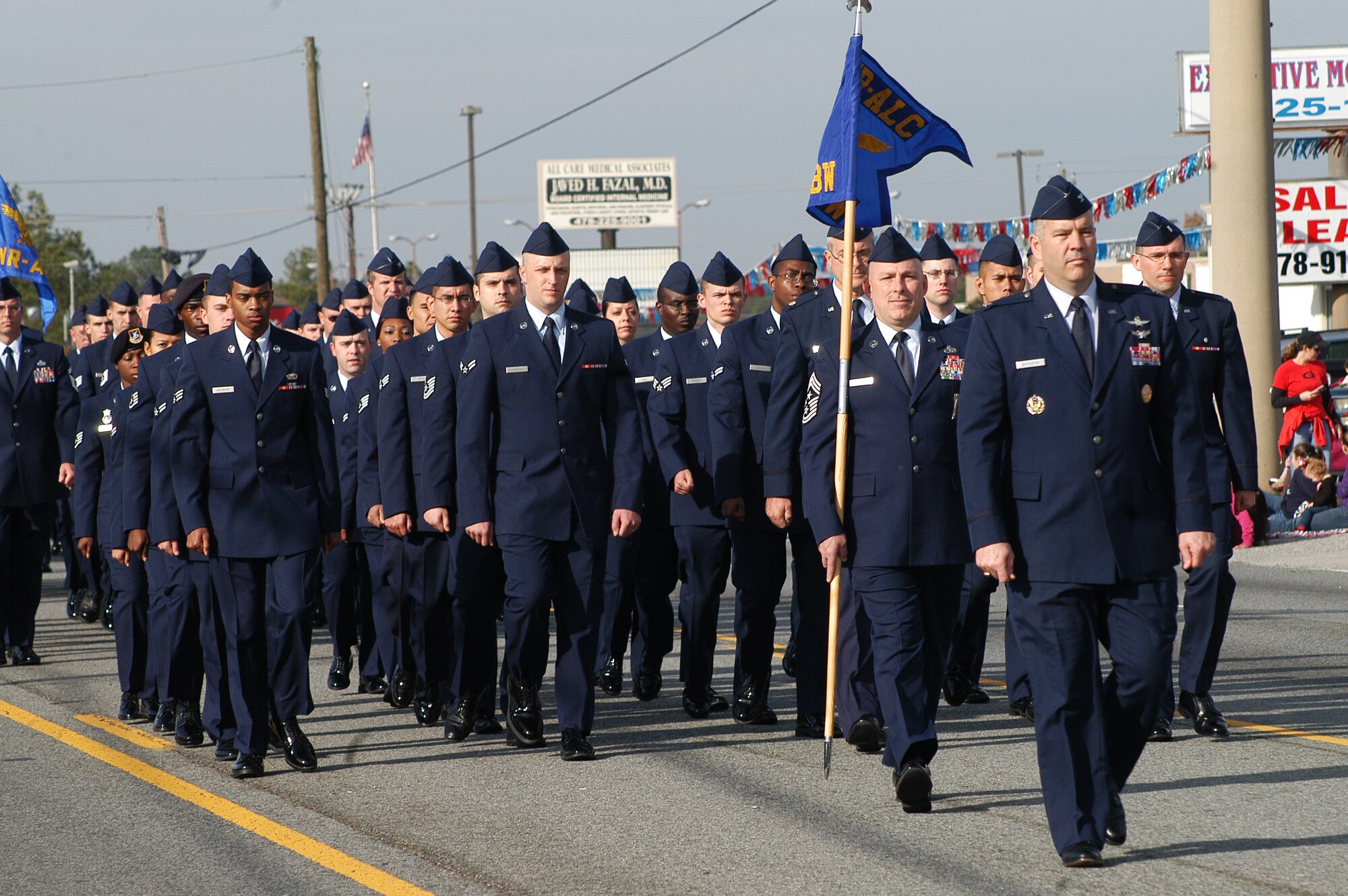 Col. Mitch Butikofer, 78th Air Base Wing commander, front,  and Chief Master Sgt. Patrick Bowen, installation command chief, with guidon, leads a formation of Airmen in the 2012 Warner Robins Christmas Parade  (U. S. Air Force photo/Sue Sapp)