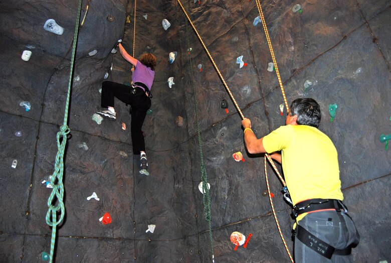 A climber learns to navigate the rock climbing wall at the Peterson Sports and Fitness Center during a certification class Oct. 14. The class is open to all ages; children must be big enough to fit into one of the harnesses. Classes are offered every second Tuesday at 5 p.m. and every second Wednesday at 11:30 a.m. (U.S. Air Force photo/Lea Johnson)