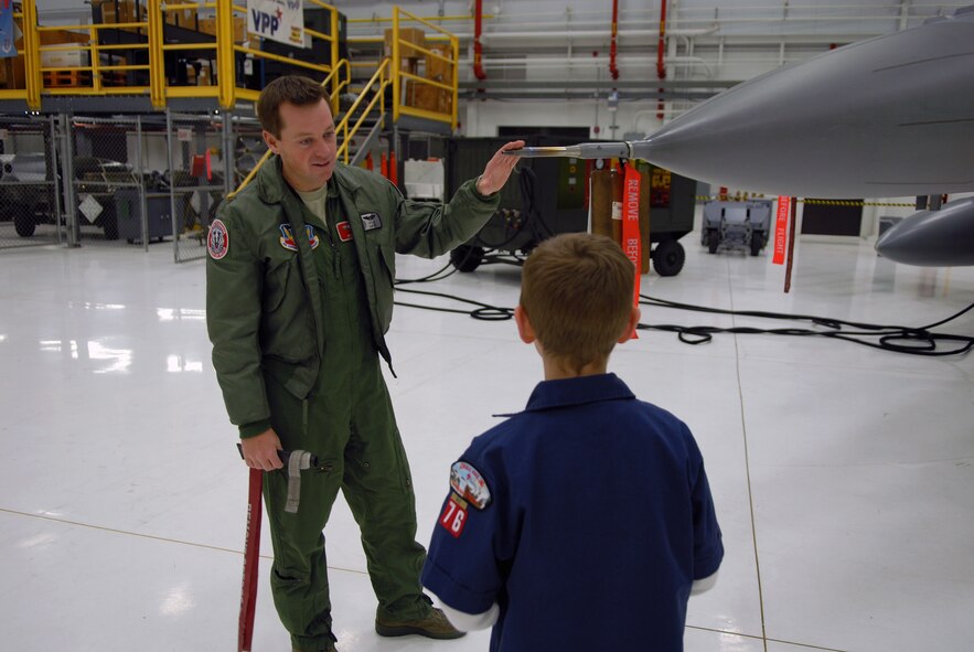 2nd Lt. Kyle Lukey, a pilot with the 115th Fighter Wing, Madison, Wis., explains the purpose of the pitot tube on an F-16 fighter aircraft to a cub scout from Pack 76 of Marshal, Wis., June 29, 2012.  Cub Scout Pack 76 was at the fighter wing for a base tour. (U.S. Air Force photo by 2nd Lt. Stephen Montgomery)

