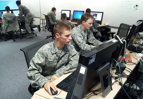 Cadets 1st Class Frank Adkins and Michael Winstead (foreground) search for vulnerabilities on opposing teams' virtual servers during the RWTH 2012 Capture the Flag competition. The Air Force Academy's Cyber Competition Team took fourth place overall and first place among U.S. teams in the 12-hour contest. RWTH is a technology research university in Aachen, Germany. (U.S. Air Force photo/Dr. Martin Carlisle)