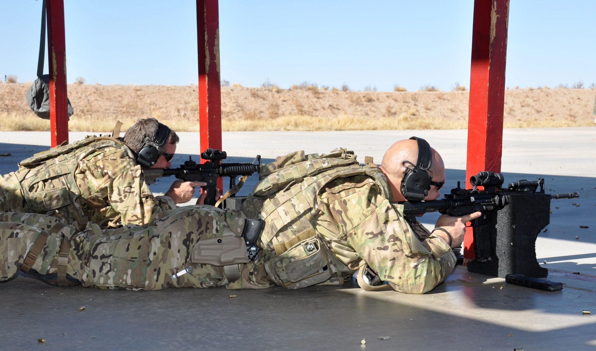 Senior Master Sgt. Michael Flake and Master Sgt. Edward Dawson, both with the 305th Rescue Squadron, shoot the M-4 rifle during a weapons qualification shoot during the 943rd Rescue Group’s Unit Training Assembly weekend. Aircrew with the 305th RQS are required to maintain a high level of proficiency in weapons handling. (U.S. Air Force Photo/ Staff Sgt. Sarah Pullen)