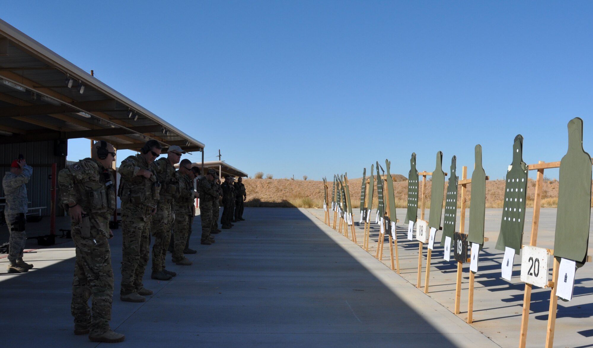 Aircrews from the 305th Rescue Squadron prepare to begin the 9MM pistol portion of a weapons qualification shoot during the December Unit Training Assembly Weekend. The 305th RQS aircrews are required to maintain a high level of weapon handling proficiency. (U.S. Air Force Photo/ Staff Sgt. Sarah Pullen)  