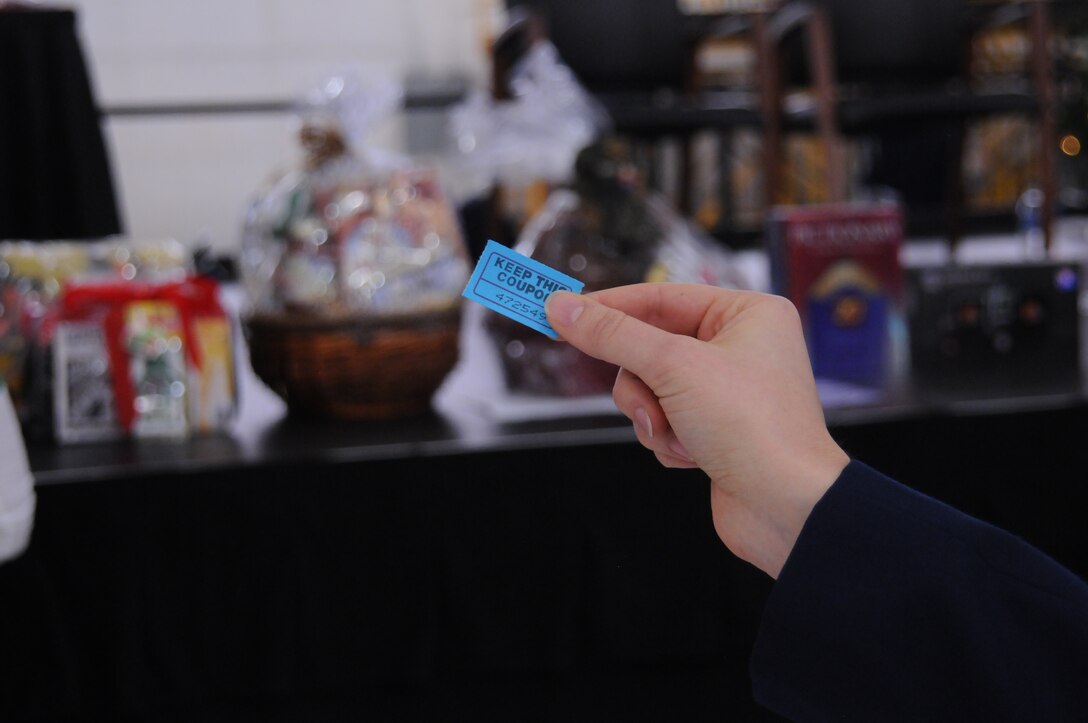 YOUNGSTOWN AIR RESERVE STATION, Ohio -- A U.S. Air Force Reserve Airman checks her ticket for the winning number Dec. 2, 2012 during the December Unit Training Assembly here. The 910th Airlift Wing Chief's Group hosted a holiday party at the conclusion of commander's call and they awarded Airmen gift baskets and prizes. (U.S. Air Force photo by Senior Airman Ron Dombkowski) 