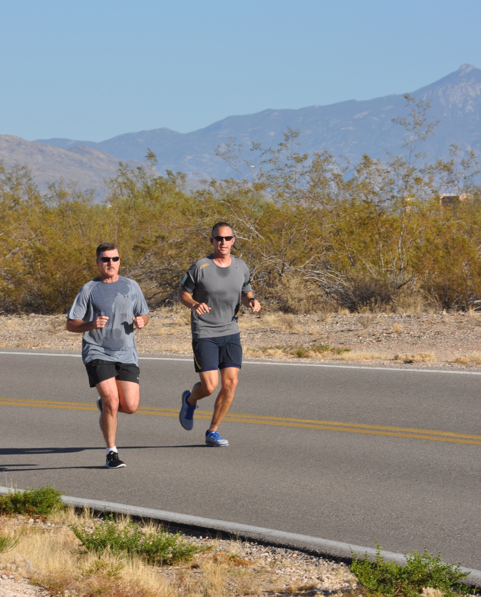 Lt. Col. John Beatty, 943rd Rescue Group deputy commander and Maj. Terry Rosenbalm, 943rd Maintenance Squadron commander run the final stretch of the 10 kilometer run during the first ever 943rd RQG fun run, December 2. The 943rd RQG Top 3 organized the fun run to help promote physical fitness for rescue group Airmen. (U.S. Air Force Photo/ Staff Sgt. Sarah Pullen) 