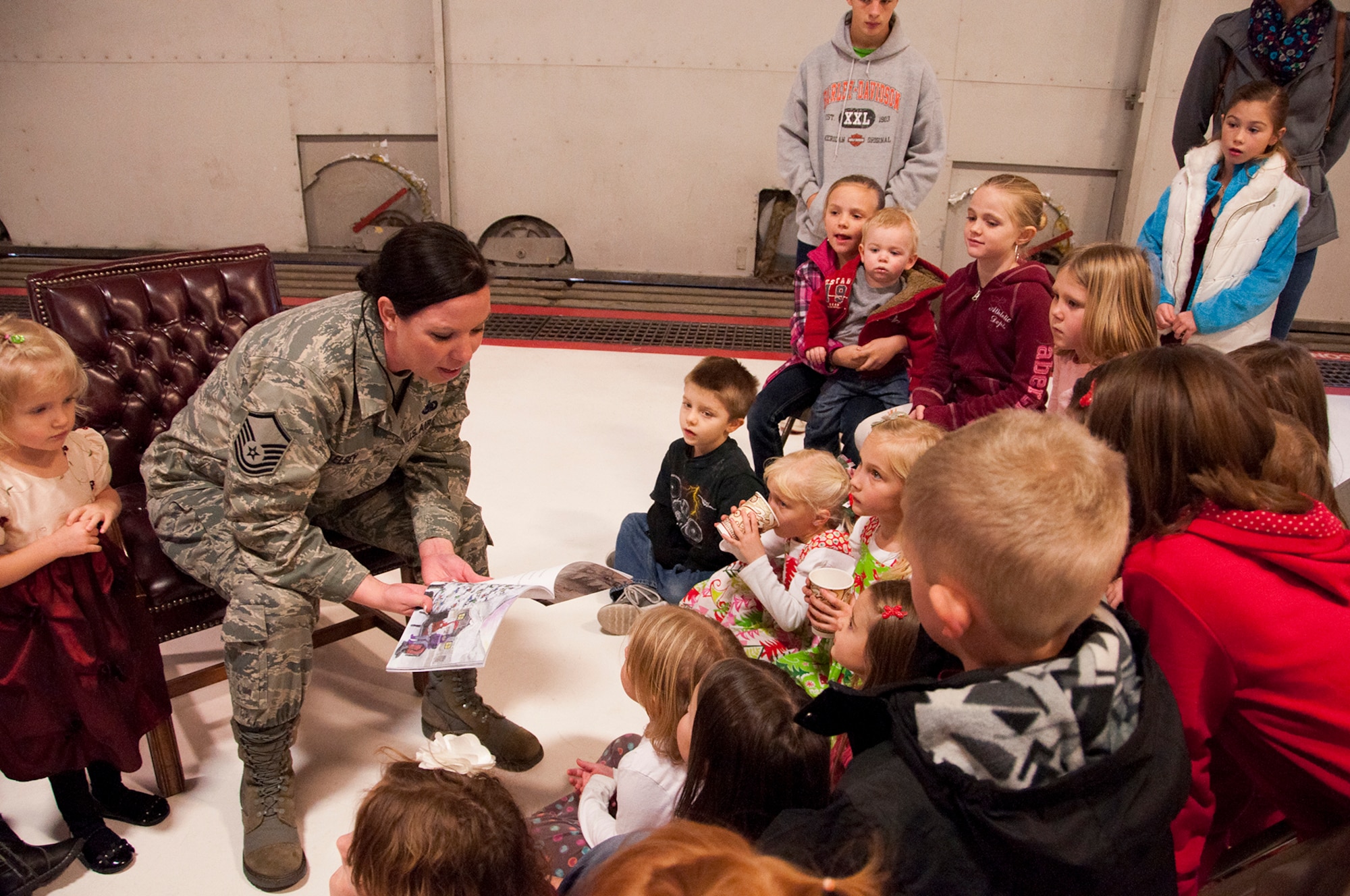 Master Sgt. Angelia Kelsey, 419th Logistics Readiness Squadron, reads Molly’s Christmas Wish, a book she wrote and self-published, to reservists’ children during the 419th Fighter Wing’s Christmas party here Dec. 2. Kelsey is a maintenance supply liaison and has traveled around the world as part of her military duties, having served for more than 11 years. Before joining the 419th, Kelsey was stationed at Joint Base Elmendorf-Richardson, Alaska – a setting that inspired the new book. She is currently visiting schools across Northern Utah to promote the book. (U.S. Air Force photo/Senior Airman Crystal Charriere)