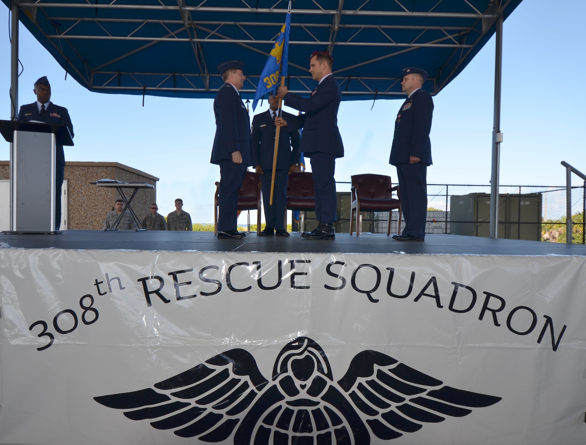 Col. Mark Blalock, 920th Rescue Wing operations group commander, hands the 308th Rescue Squadron guidon to Maj. John Fish in a ceremonial gesture that represents his taking command. Fish assumed command from Lt. Col. Kurt Matthews Sunday during the 920th RQW's Unit Training Assembly. (U.S. Air Force photo/2nd Lt. Leslie Forshaw) 