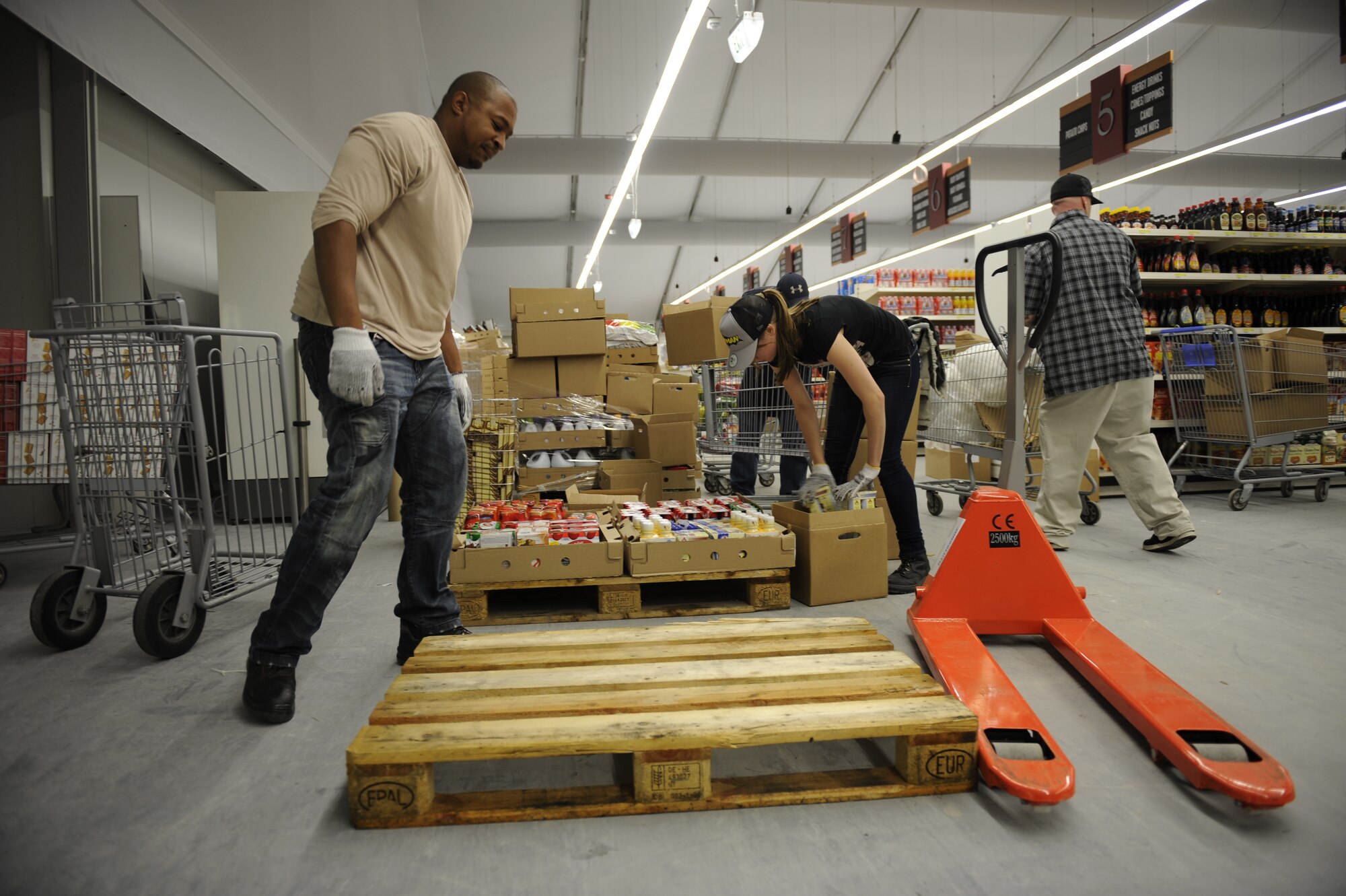 Employees move products into the new Commissary from the old building, at Ramstein Air Base, Germany, Nov. 05, 2012. The new commissary will be built to accommodate a larger amount of costumer. (U.S. Air Force Air Base Senior Airman Aaron-Forrest Wainwright) 