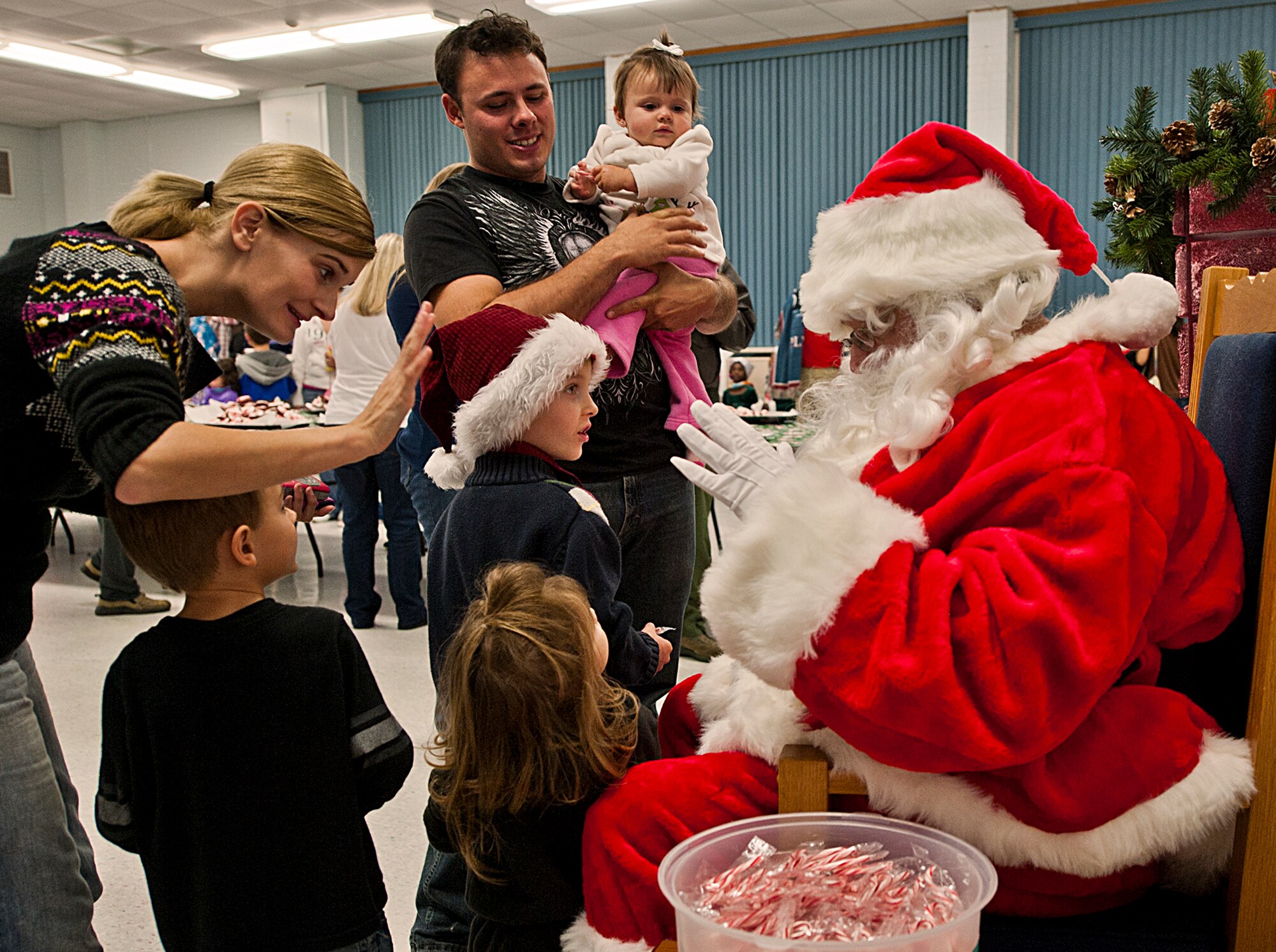 The Mihalko family from Army 7th Special Forces Group meets Santa during Team Eglin’s annual Christmas tree lighting ceremony Nov. 30 at the installation’s West Gate Chapel. Chaplains and senior leadership led the event with messages of unity and awards for the base-wide, life-sized card decoration contest. Children from the Chapel and Arts Ministry Program served as the choir. Santa arrived in a fire truck before his photo opportunity with hundreds of children from the base.  (U.S. Air Force photo/Chrissy Cuttita)