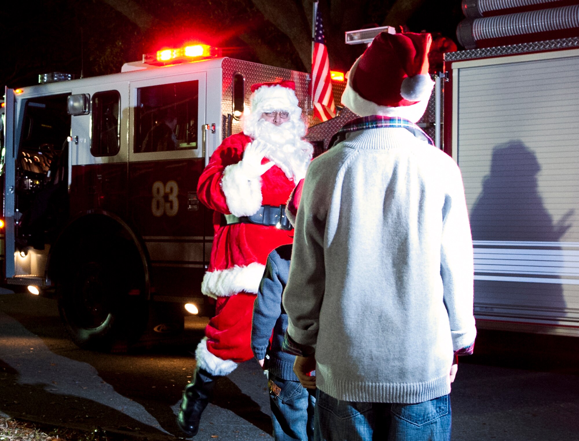 Two boys get close up to the fire truck Santa rode in to get a glimpse of their holiday hero during Team Eglin’s annual Christmas tree lighting ceremony Nov. 30 at the installation’s West Gate Chapel. Chaplains and senior leadership led the event with messages of unity and awards for the base-wide, life-sized card decoration contest. Children from the Chapel and Arts Ministry Program served as the choir. (U.S. Air Force photo/Chrissy Cuttita)