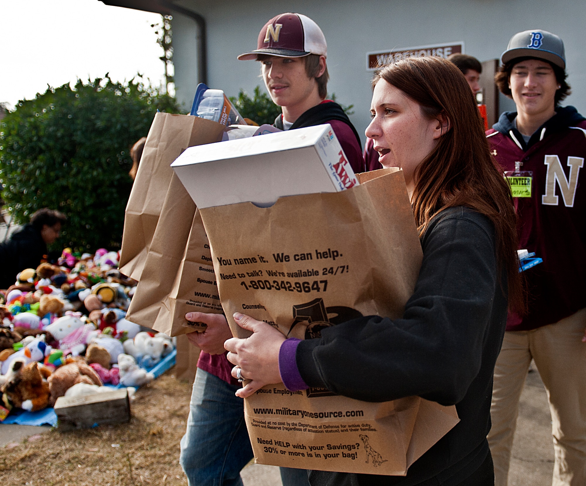 Josh Smith and Connor Levesque of Niceville High School carry toys for Brianne Slominsky during the 9th annual toy distribution at Eglin Air Force Base, Fla. Nov. 29.  Approximately 80 volunteers helped in the delivery of toys this year. More than 6,000 toys, collected by donations made throughout the year, were passed out to active-military families in need of assistance during the holidays. (U.S. Air Force photo/Randy Gon)
