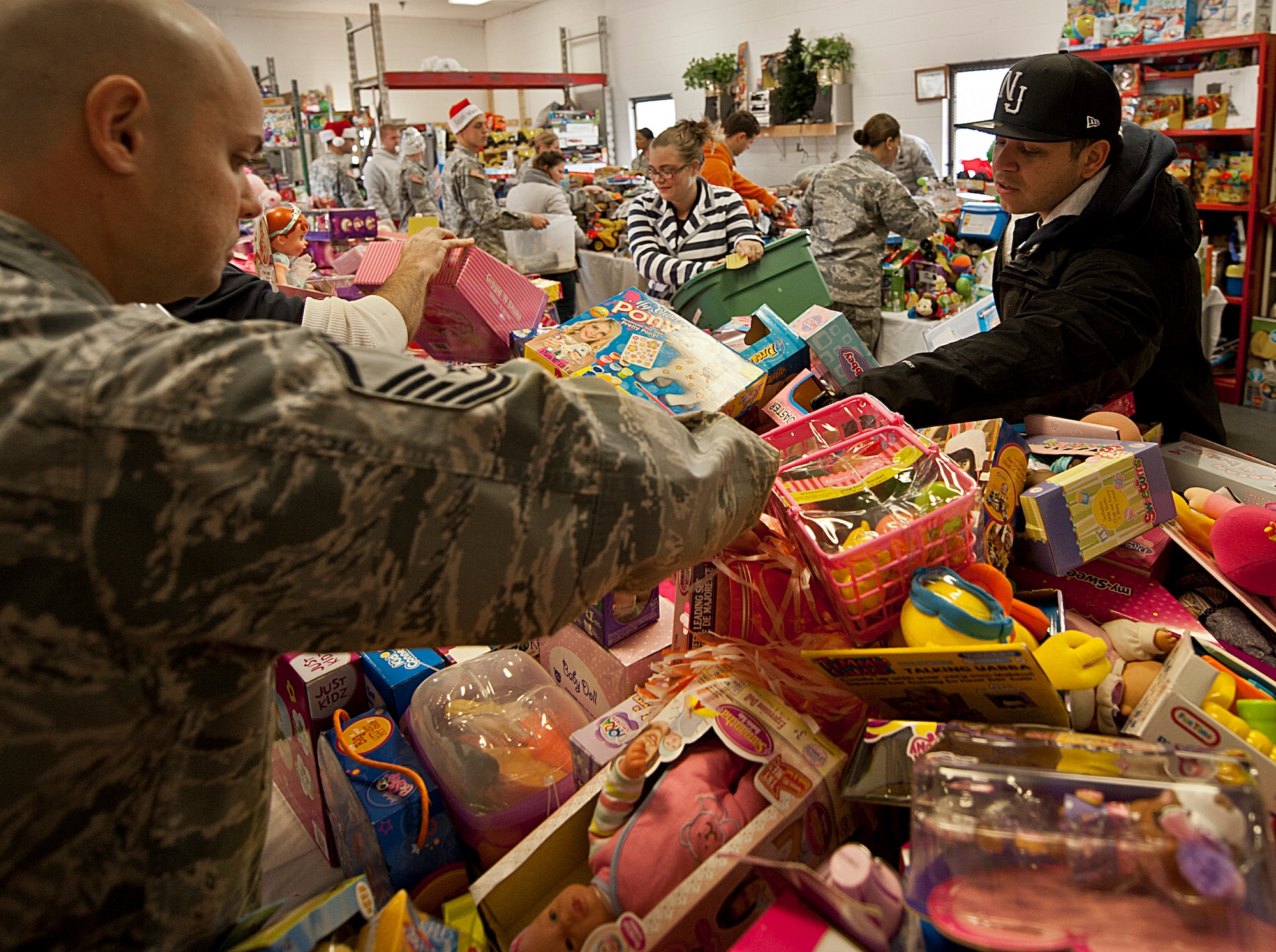 Airman’s Attic volunteers help parents find toys during the 9th annual toy distribution at Eglin Air Force Base, Fla. Nov. 29.  More than 6,000 toys, collected by donations made throughout the year, were distributed to active-military families in need of assistance during the holidays. (U.S. Air Force photo/Randy Gon)