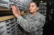 Airman 1st Class Sanna Shabbir, 60th Aerial Port Squadron cargo processing specialist, installs a Radio Frequency Identification tracker onto a 463L pallet Wednesday on Travis.