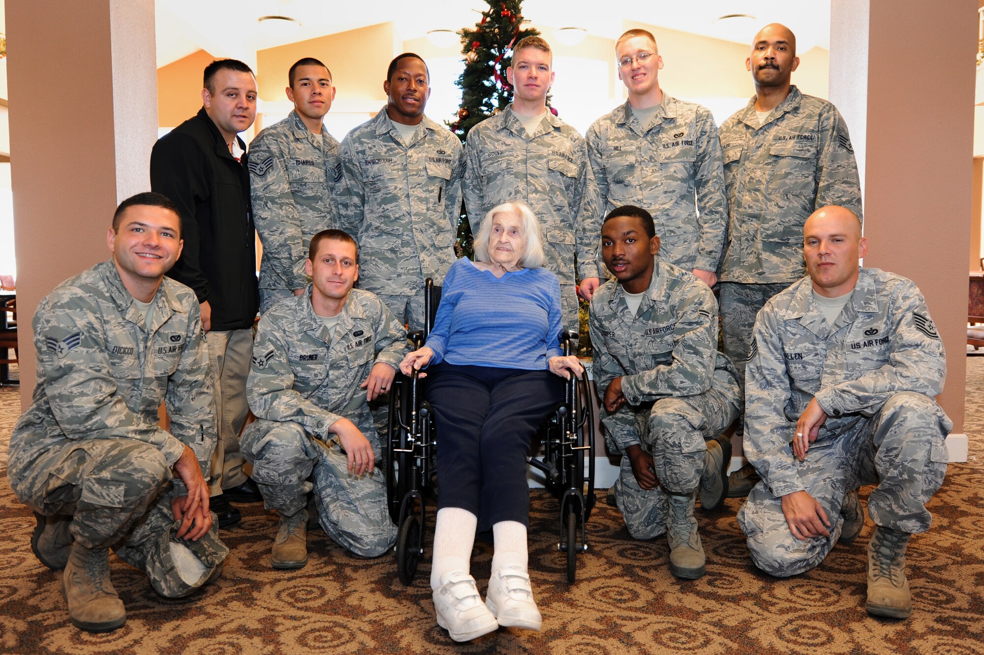 Air Commandos pose with 95-year-old Louis Rodden after moving her belongings to a new room in Wheatfields Senior Living Community in Clovis, N.M., Nov. 29, 2012.  Members from Cannon air Force Base, N.M., offered to lend a helping hand at Wheatfields if ever it was needed. (U.S. Air Force photo/Senior Airman Jette Carr)