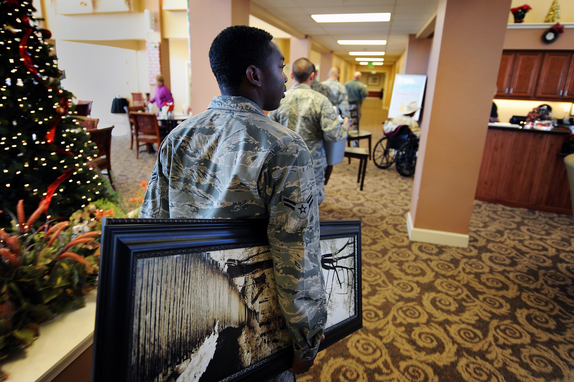 Airmen from Cannon Air Force Base, N.M., move a resident’s belongings to a new room in Wheatfields Senior Living Community in Clovis, N.M., Nov. 29, 2012.  Members of the base offered to lend a helping hand at Wheatfields if ever it was needed. (U.S. Air Force photo/Senior Airman Jette Carr)