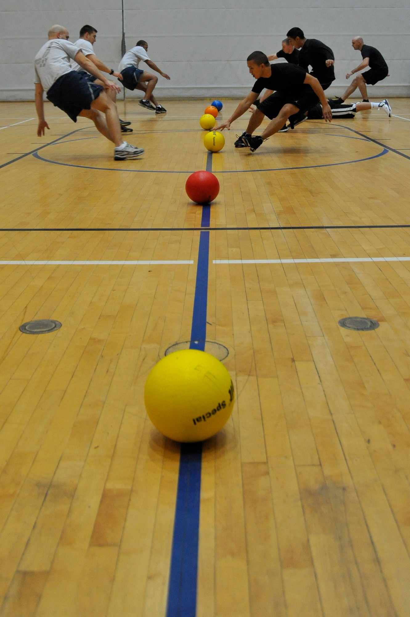 Airmen with the 569th United States Forces Police Squadron and the 86th Maintenance Squadron rush to grab a dodgeball at the beginning of the championship game of the dodgeball tournament, Ramstein Air Base, Germany, Nov. 30, 2012 The 786th Force Support Squadron hosted the tournament in order to foster teamwork and promote morale. (U.S. Air Force photo/Airman 1st Class Trevor Rhynes)