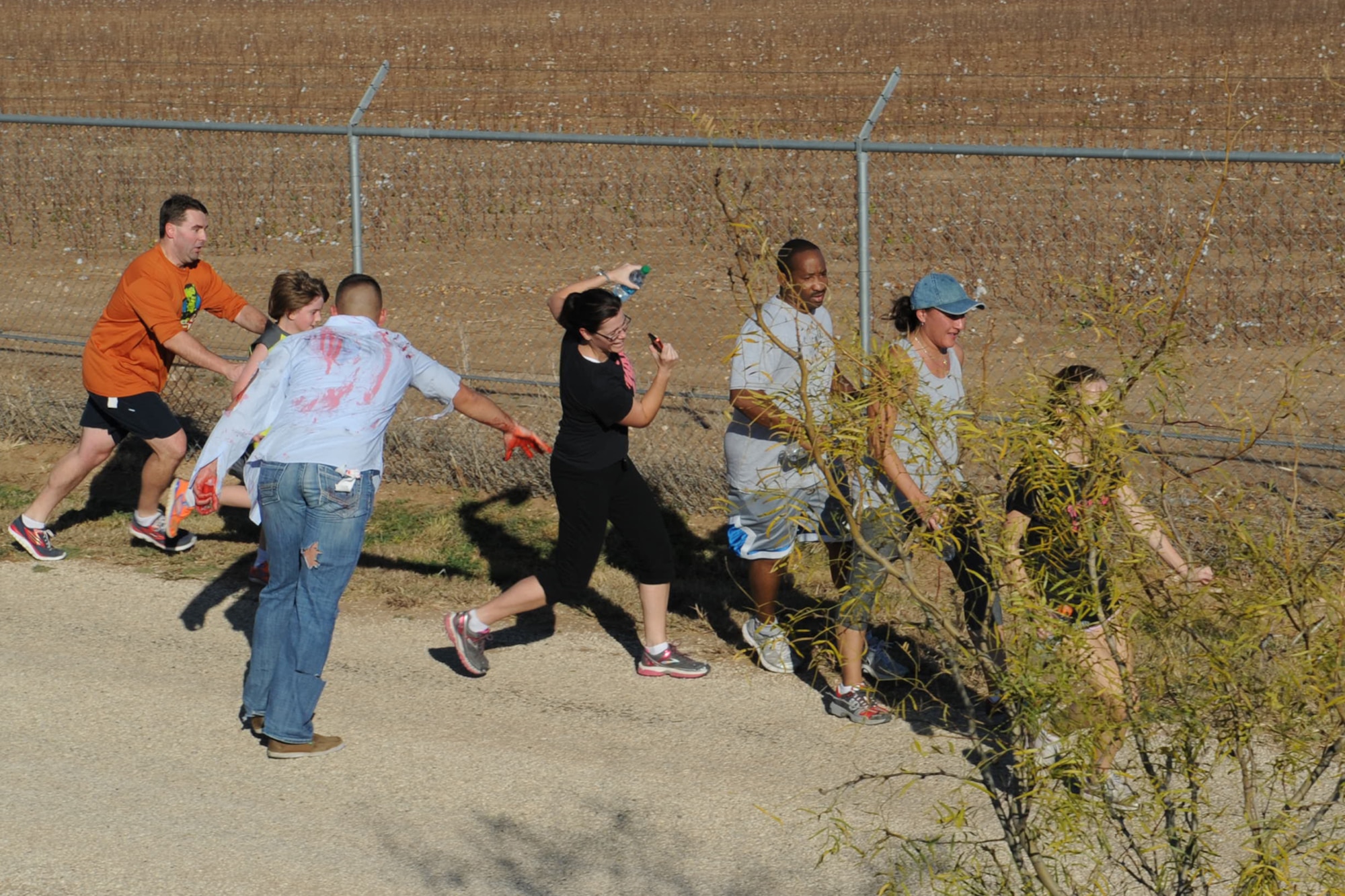 Runners avoid the living dead at Goodfellow Air Force Base, Texas, during the 1st ever Zombie Run, Dec. 1, 2012. (U.S. Air Force photo by Staff Sgt. Laura R. McFarlane)  