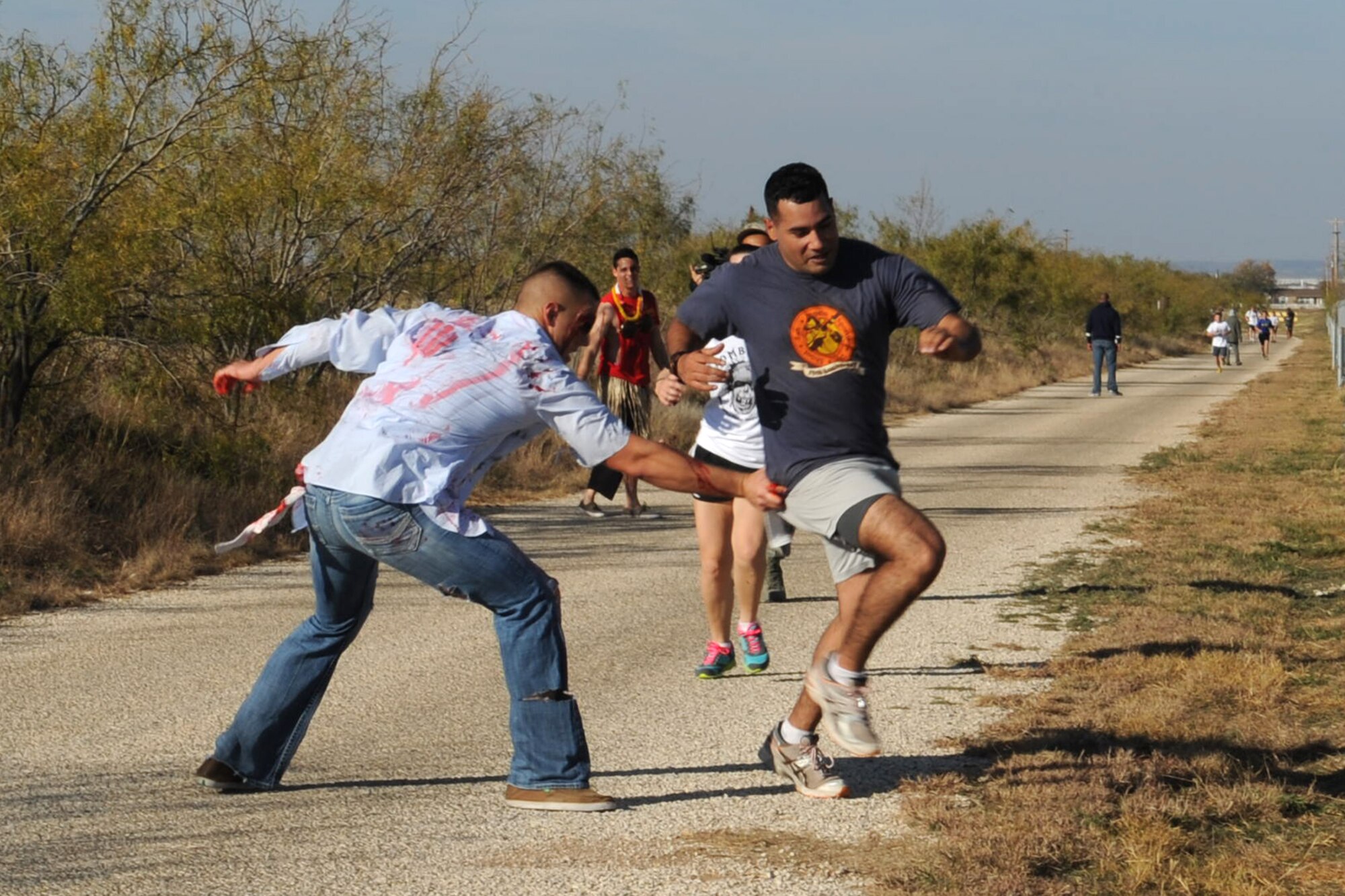 U.S. Marine Corps Lance Cpl. Zack Moore, Marine Corps Detachment (MCD) Goodfellow, attacks Sgt. Cimarron Rodriquez, MCD, during the 1st ever Zombie Run at Goodfellow Air Force Base, Texas, Dec. 1, 2012. (U.S. Air Force photo by Staff Sgt. Laura R. McFarlane)  