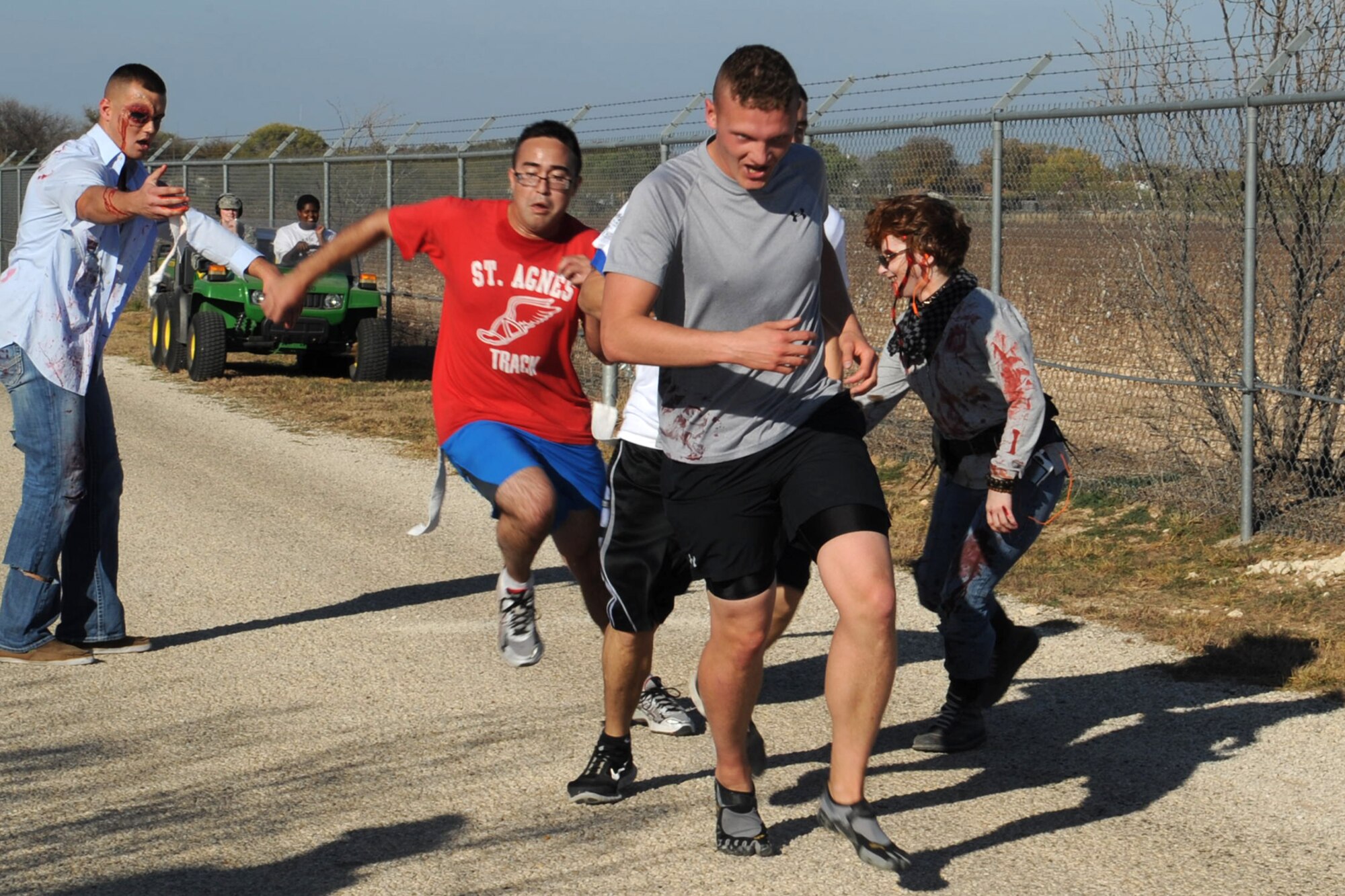 The living dead come to life at Goodfellow Air Force Base, Texas, as zombies attack runners during the 1st ever Zombie Run, Dec. 1, 2012. (U.S. Air Force photo by Staff Sgt. Laura R. McFarlane)  
