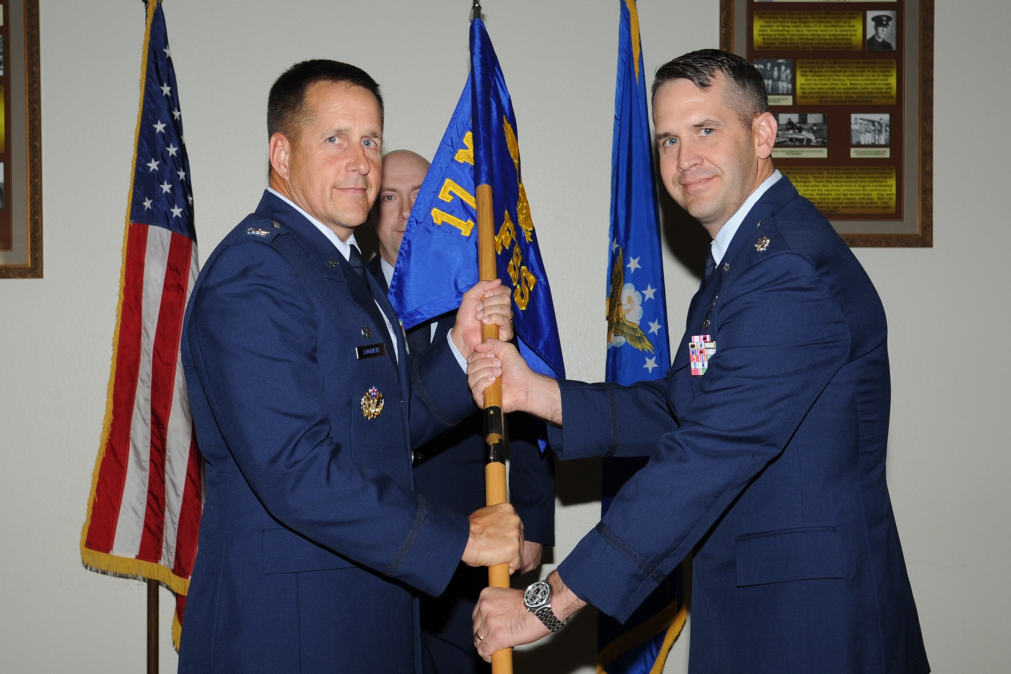 U.S. Air Force Col. Paul Bugenske, 17th Mission Support Group commander, passes the 17th Force Support Squadron guidon to Lt. Col. Ryan Dahl, during a change of leadership ceremony at Goodfellow Air Force Base, Texas, Nov. 30, 2012. Dahl assumed command of the 17th FSS from Mike Sampson. (U.S. Air Force photo by Staff Sgt. Laura R. McFarlane)