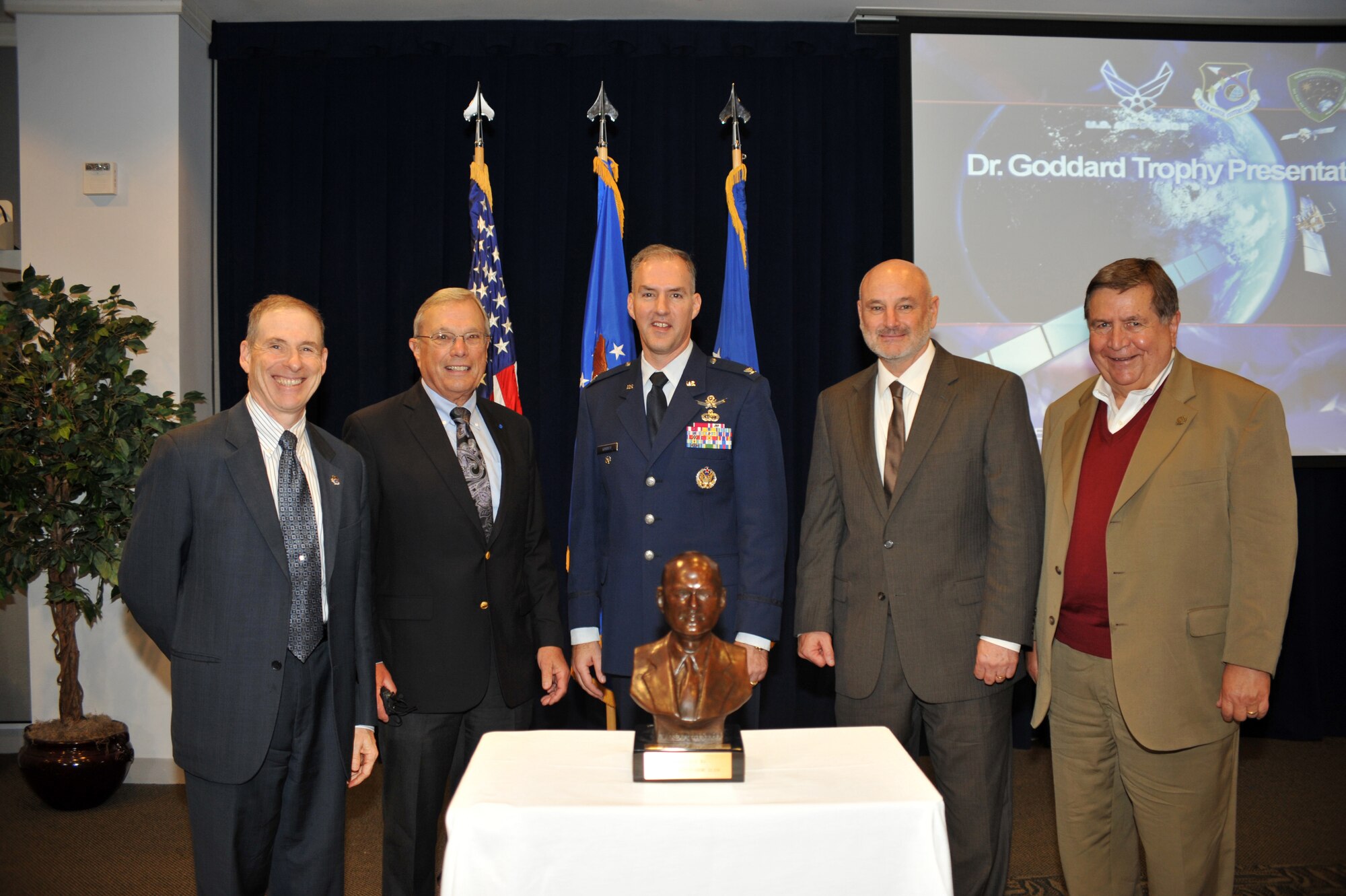 Members, past and present, of the Global Positioning Systems Directorate (GPS) stand behind the Dr. Robert  H. Goddard Memorial Trophy, which was awarded to the GPS Directorate in a ceremony held at Los Angeles Air Force Base in El Segundo, Calif. on November 30th, 2012.  From left to right are Mr. Douglas L. Loverro, Executive Director, Space and Missile Systems Center (SMC); Dr. Bradford W. Parkinson, Chief Architect for GPS in 1973;  U.S. Colonel Bernie J. Gruber, current Commander, GPS Directorate; David W. Madden, current Director, Military Satellite Communications  Systems Directorate at SMC and GPS Wing commander 2007 to 2010; and U.S Air Force (Retired) Colonel Gaylord Green, GPS Program Director from 1985 to 1988.   The Dr. Robert  H. Goddard Memorial Trophy is presented annually by the National Space Club to recognize significant contributions to United States leadership in the field of rocketry and astronautics.  Past winners of the Dr. Robert  H. Goddard Memorial Trophy include Presidents Ronald Reagan and Lyndon Johnson, Dr. Sheila Widnall, Dr. Charles Draper, the Apollo 11 astronauts, John Glenn (twice), and the crew who perished in the Space Shuttle Columbia disaster.  (U.S. Air Force photo by Sarah Corrice.)