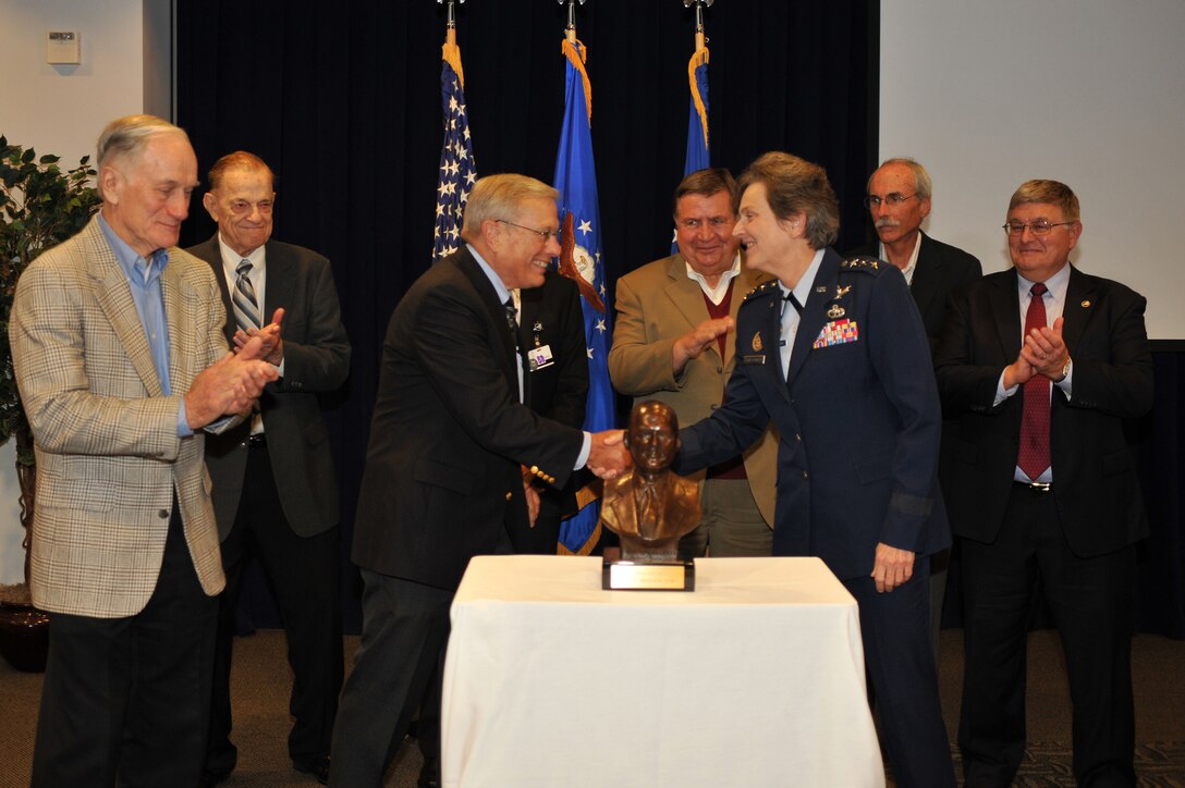 U.S Air Force Lt Gen Ellen Pawlikowski, Commander of the Space and Missile Systems Center (SMC),  shakes hands with Dr. Bradford W. Parkinson, Chief Architect for the Global Positioning System (GPS) as she accepts the Dr. Robert  H. Goddard Memorial Trophy on behalf of the Global Positioning Systems Directorate in a ceremony attended by members of the GPS Originators team and held at Los Angeles Air Force Base in El Segundo, Calif. on November 30th, 2012.  The Dr. Robert  H. Goddard Memorial Trophy is presented annually by the National Space Club to recognize significant contributions to United States leadership in the field of rocketry and astronautics.  Past winners of the Dr. Robert  H. Goddard Memorial Trophy include Presidents Ronald Reagan and Lyndon Johnson, Dr. Sheila Widnall, Dr. Charles Draper, the Apollo 11 astronauts, John Glenn (twice), and the crew who perished in the Space Shuttle Columbia disaster.  (U.S. Air Force photo by Sarah Corrice.)