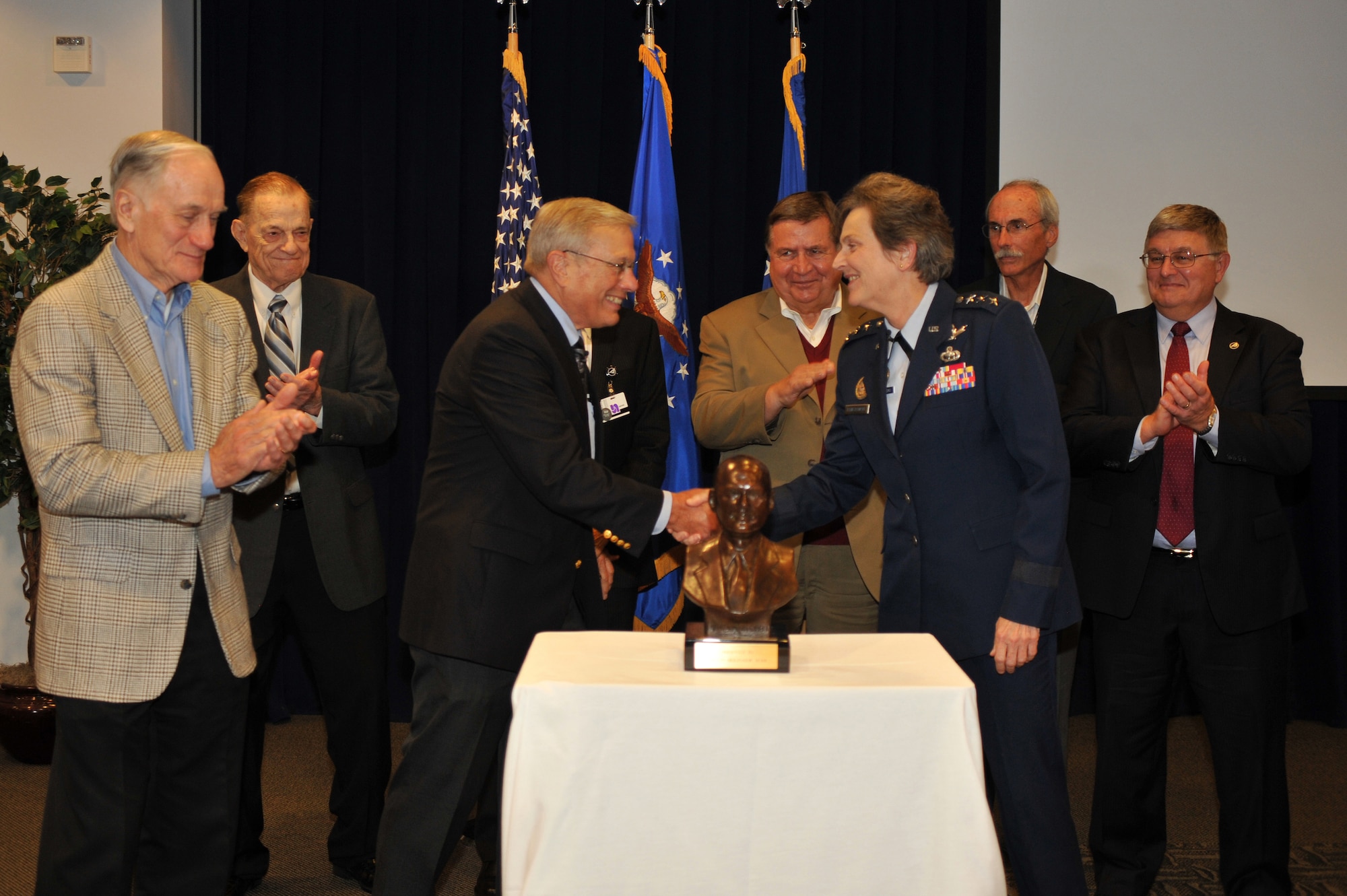 U.S Air Force Lt Gen Ellen Pawlikowski, Commander of the Space and Missile Systems Center (SMC),  shakes hands with Dr. Bradford W. Parkinson, Chief Architect for the Global Positioning System (GPS) as she accepts the Dr. Robert  H. Goddard Memorial Trophy on behalf of the Global Positioning Systems Directorate in a ceremony attended by members of the GPS Originators team and held at Los Angeles Air Force Base in El Segundo, Calif. on November 30th, 2012.  The Dr. Robert  H. Goddard Memorial Trophy is presented annually by the National Space Club to recognize significant contributions to United States leadership in the field of rocketry and astronautics.  Past winners of the Dr. Robert  H. Goddard Memorial Trophy include Presidents Ronald Reagan and Lyndon Johnson, Dr. Sheila Widnall, Dr. Charles Draper, the Apollo 11 astronauts, John Glenn (twice), and the crew who perished in the Space Shuttle Columbia disaster.  (U.S. Air Force photo by Sarah Corrice.)