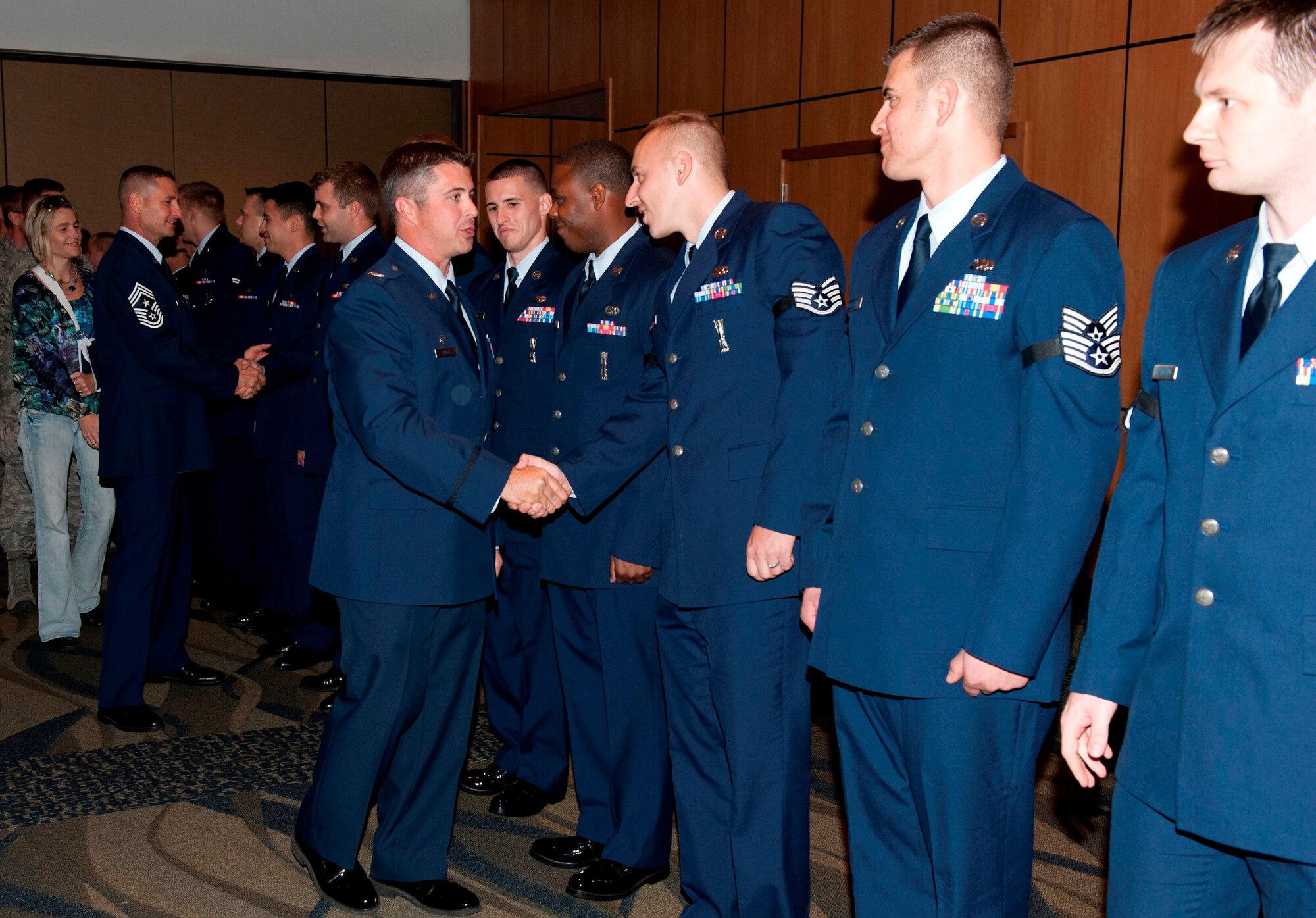 Col. David Graff, 325th Fighter Wing commander, and members of Team Tyndall congratulate the November promotees. (U.S. Air Force photo by Lisa Norman)