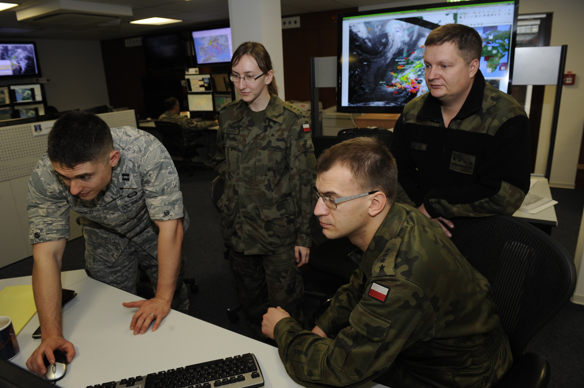 Polish Meteorological & Oceanographic Officers tour the operation floor at the 21st Operations Weather Squadron at Ramstein Air Base, Germany, Nov. 28, 2012. The Polish METOC officers are here to observe the procedures for airfield support. (U.S. Air Force photo by Senior Airman Aaron-Forrest Wainwright) 