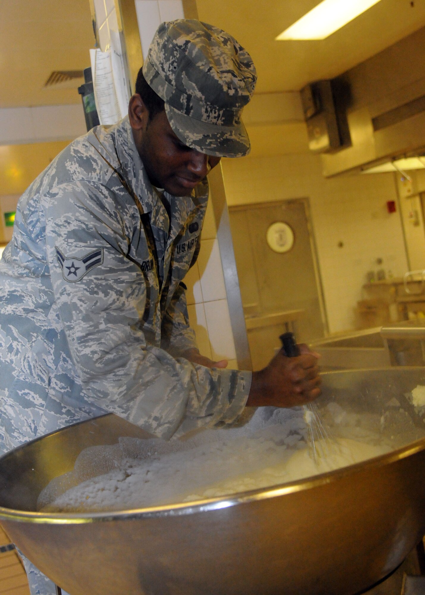 Airman 1st Class Trevor Brown, 100th Force Support Squadron services apprentice from Richmond, Va., stirs mashed potatoes for shepherd’s pie to be served during lunch Dec. 3, 2012, at the Gateway Dining Facility at RAF Mildenhall, England. The DFAC offers a variety of pre-made and cooked-to-order foods available for breakfast, lunch and dinner. (U.S. Air Force photo by Airman 1st Class Kelsey Waters/Released)