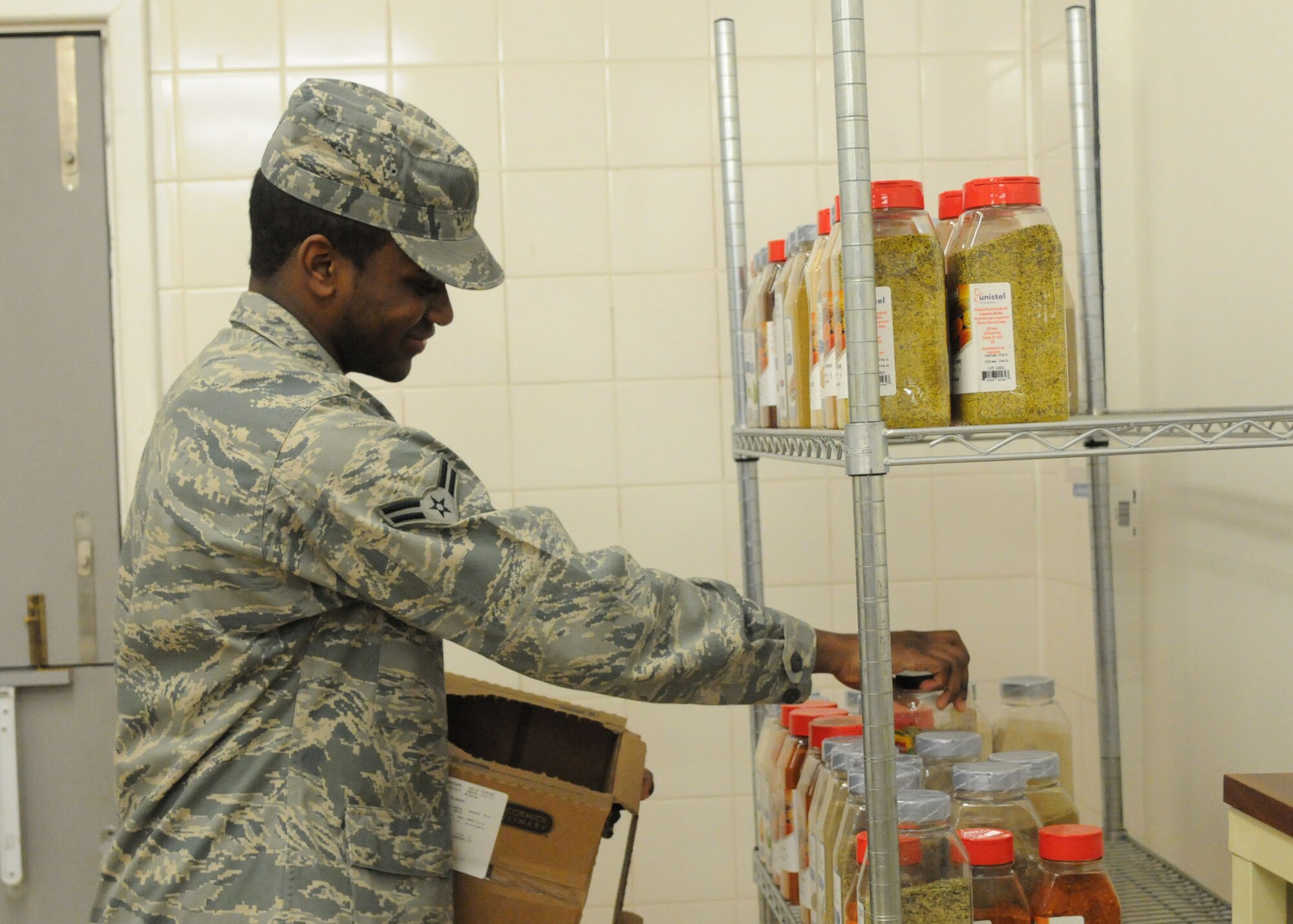 Airman 1st Class Trevor Brown, 100th Force Support Squadron services apprentice from Richmond, Va., restocks the spices in a storage room at the Gateway Dining Facility, Dec. 3, 2012, at RAF Mildenhall, England. Because of the high volume of customers the DFAC caters to, the shelves have to be restocked on a regular basis. (U.S. Air Force photo by Airman 1st Class Kelsey Waters/Released)
