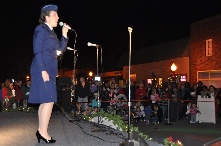 Maj. Erin Karl sings in a front of crowd during the Light Up Main event held in Garner, N.C. on Nov. 30, 2012. Karl is the deputy chief of public affairs for the 916th Air Refueling Wing and an accomplished singer. (USAF photo by Maj. Shannon Mann, 916ARW/PA)