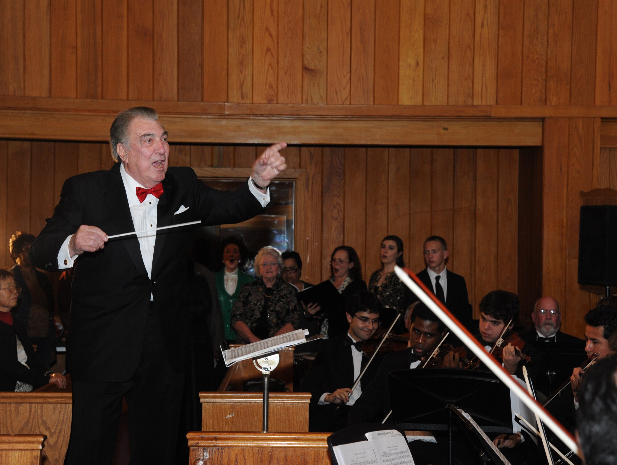 Dr. Glenn Draper, founding conductor of the Gulf Coast Messiah Chorus, is the guest conductor for the song, Hallelujah, during the Chorus’ 60th Anniversary Celebration Nov. 29, 2012, at the Triangle Chapel, Keesler Air Force Base, Miss.  Under the direction of Draper, the first performance at Keesler began a 60-year history of performances by musicians from both the military and civilian communities.  (U.S. Air Force photo by Kemberly Groue)